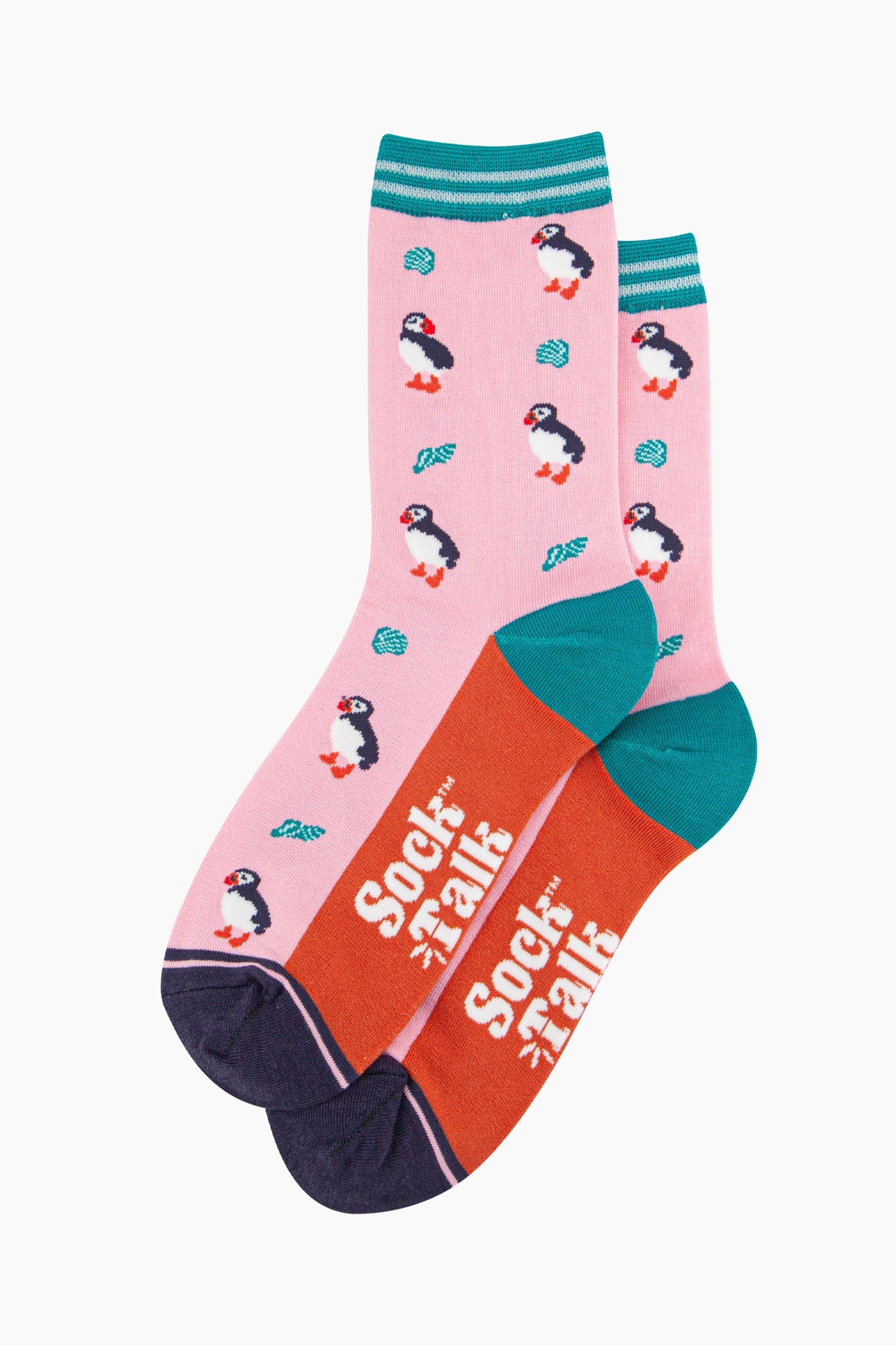 the pair of puffin and seashell socks laying flat, one on top of the other. showing clearly the all over pattern of puffin birds and seashells. the sock talk logo is visible on the base of the sole.