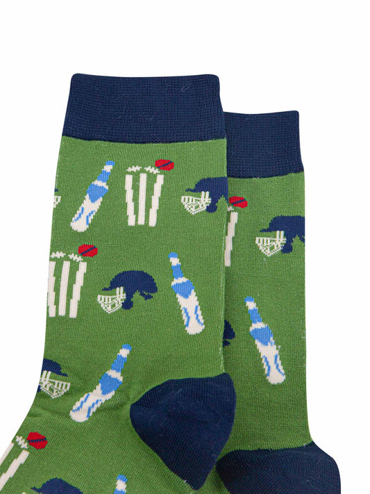 close up of the cricket kit pattern on the green bamboo socks, showing a cricket bat, stumps, ball and helmet