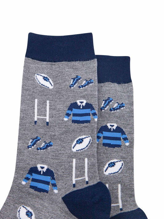 close up of the rugby goal post, ball and blue team kit pattern