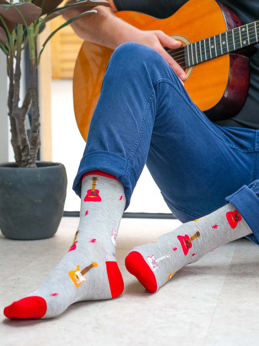 mens-electric-and-acoustic-guitar-print-bamboo-socks-man-posed-with-guitar