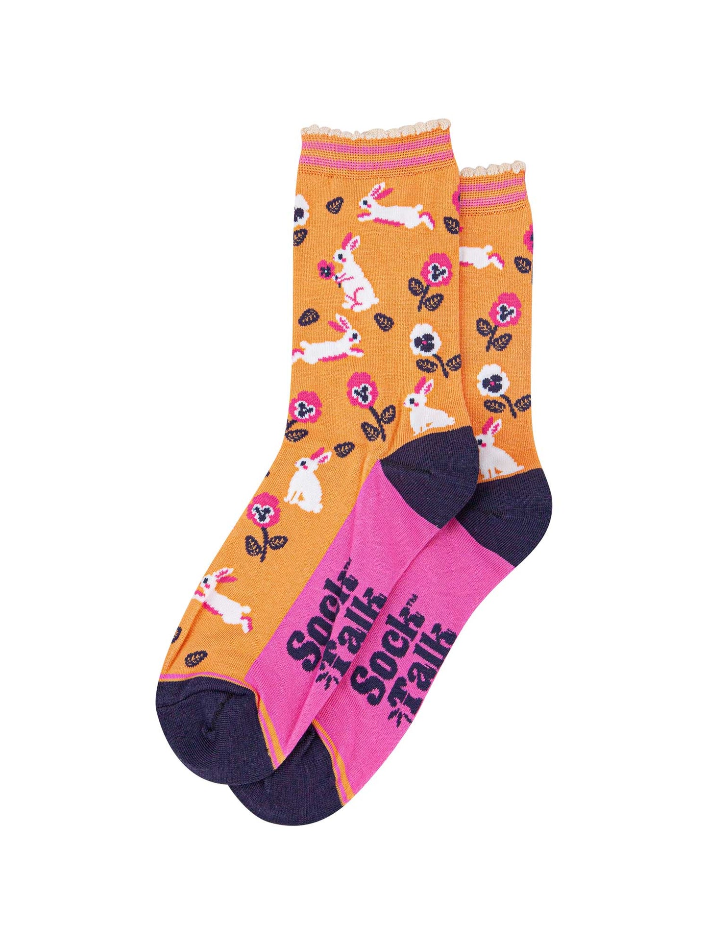 the pair of orange rabbit and flower socks laying flat, one on top of the other. showing clearly the all over pattern of white bunny rabbits, leaves and flowers.