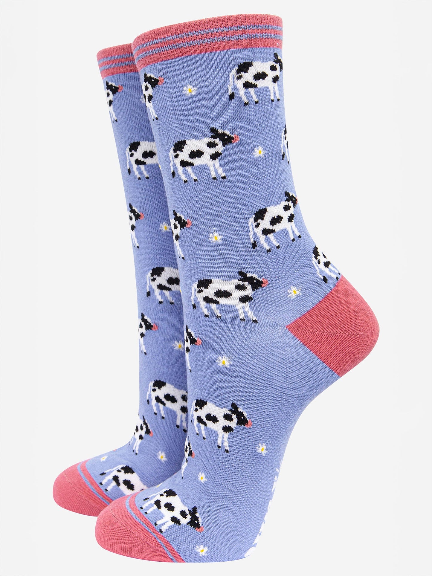 lilac and pink bamboo socks with an all over pattern of black and white cows and daisy flowers