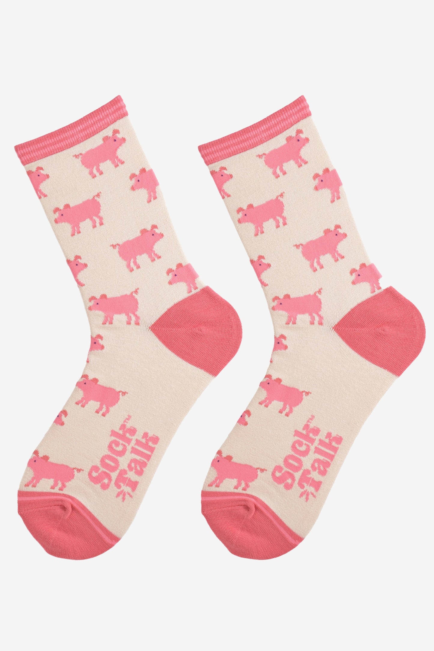 showing the cream and pink ladies pig socks laying flat, the pig pattern is all over the socks