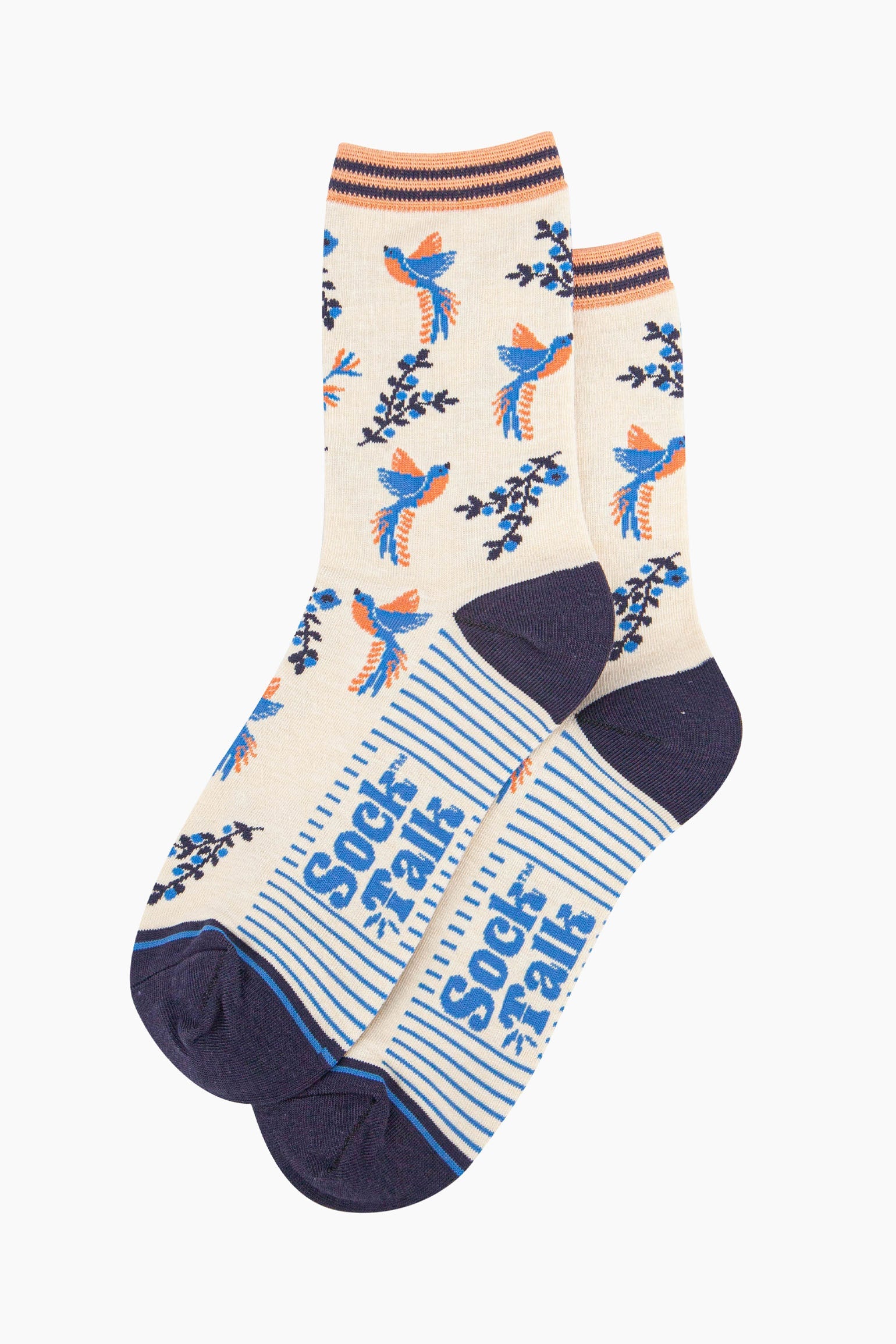 pair of cream and blue hummingbird socks laying flat, one overlapping the other. showing clearly the cream background of the socks which is contrasted by blue and orange hummingbirds. the sock talk logo is visible on the base of the sole.