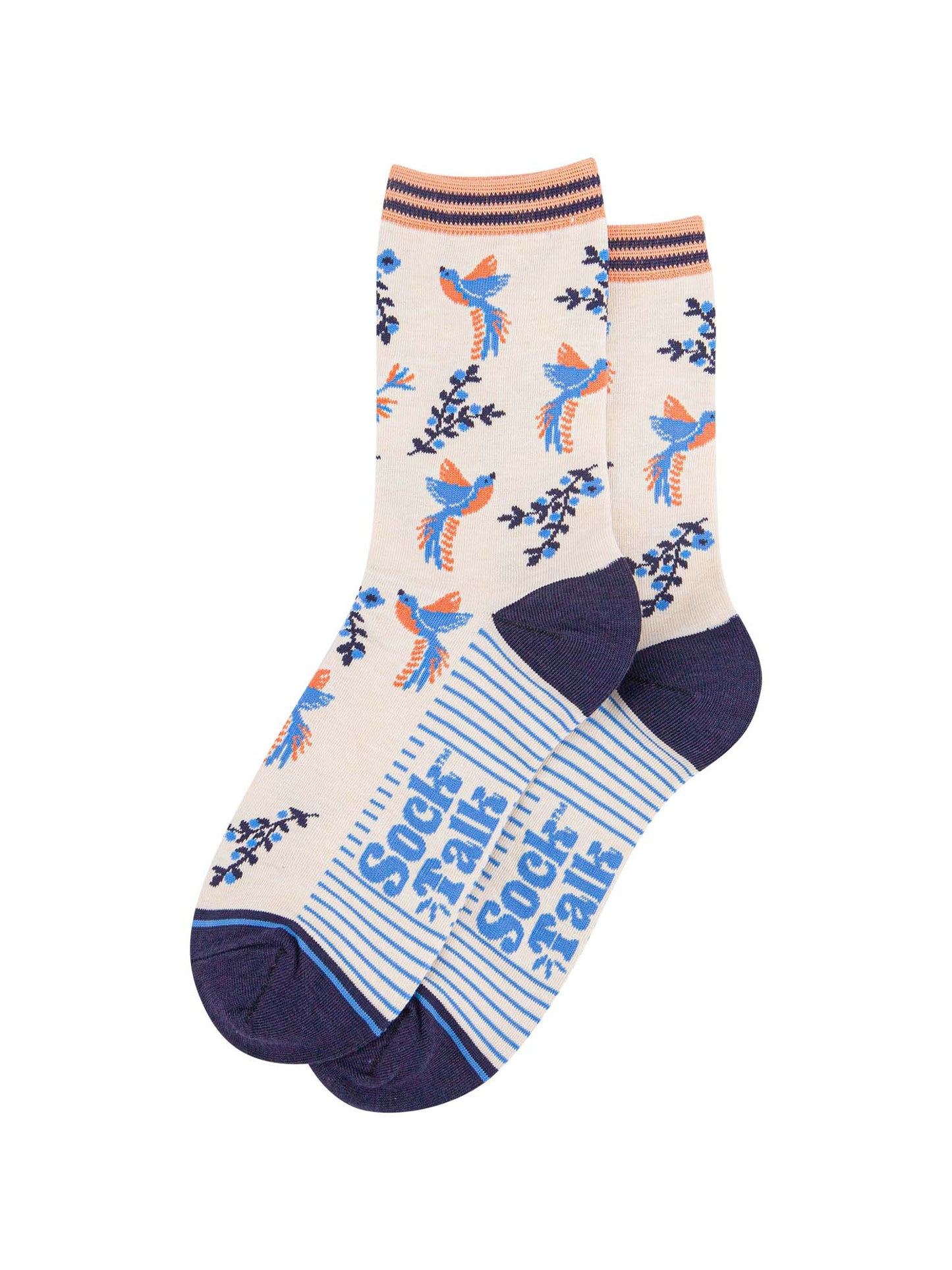 pair of cream and blue hummingbird socks laying flat, one overlapping the other. showing clearly the cream background of the socks which is contrasted by blue and orange hummingbirds. the sock talk logo is visible on the base of the sole.