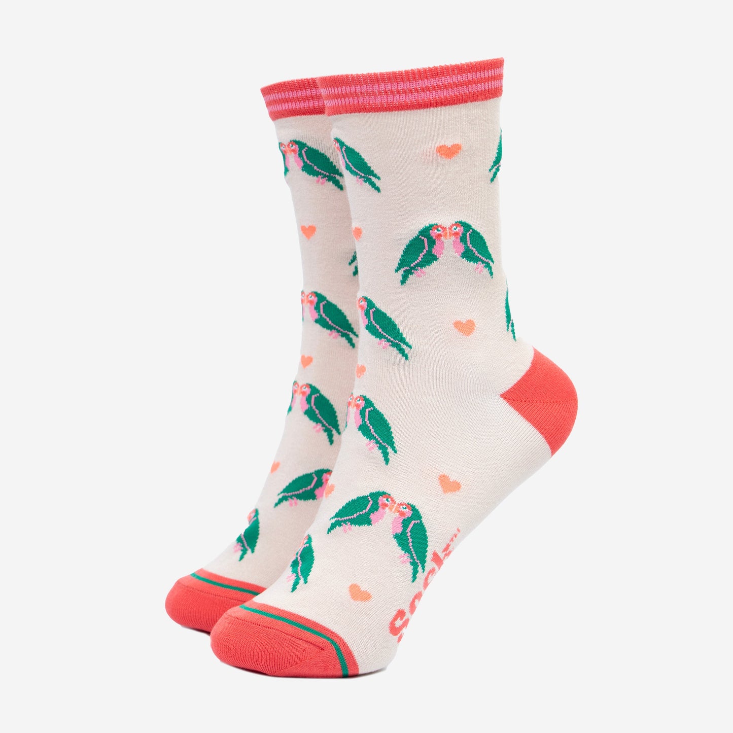cream bamboo ankle socks with a pattern of green kissing love birds and pink love hearts. the socks have a pink toe, heel and pink striped cuff