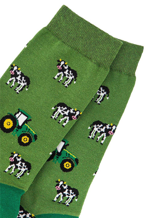 close up of the green tractors and black and white cow pattern on the bamboo socks