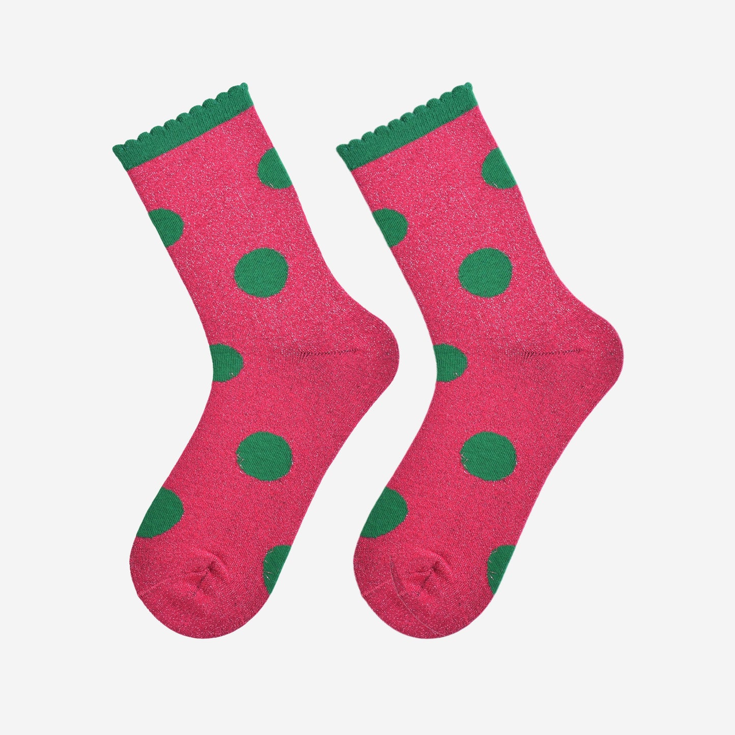 hot pink and green large polka dot pattern glitter socks laying flat, showing the all over glitter sparkle