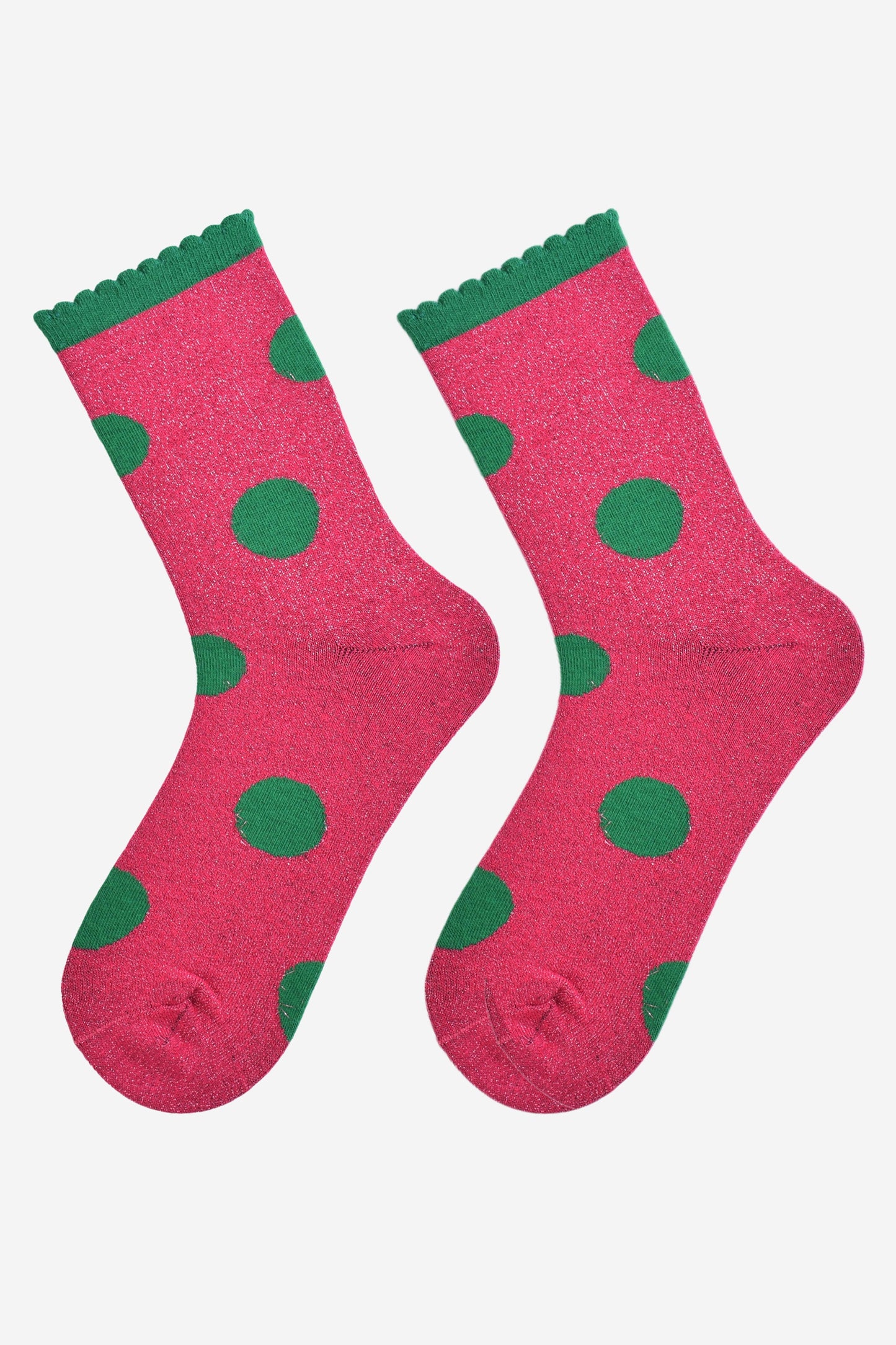 hot pink and green large polka dot pattern glitter socks laying flat, showing the all over glitter sparkle