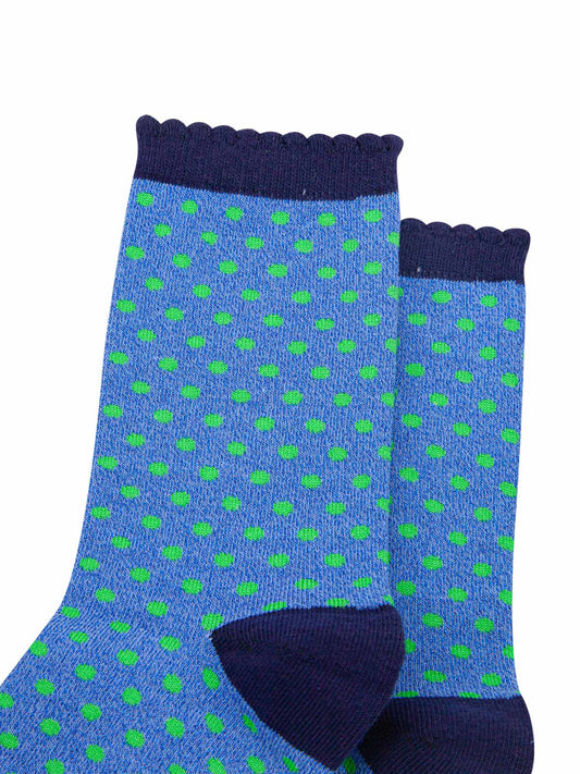 close up of the green spotted pattern and all over sparkly material of the ankle socks