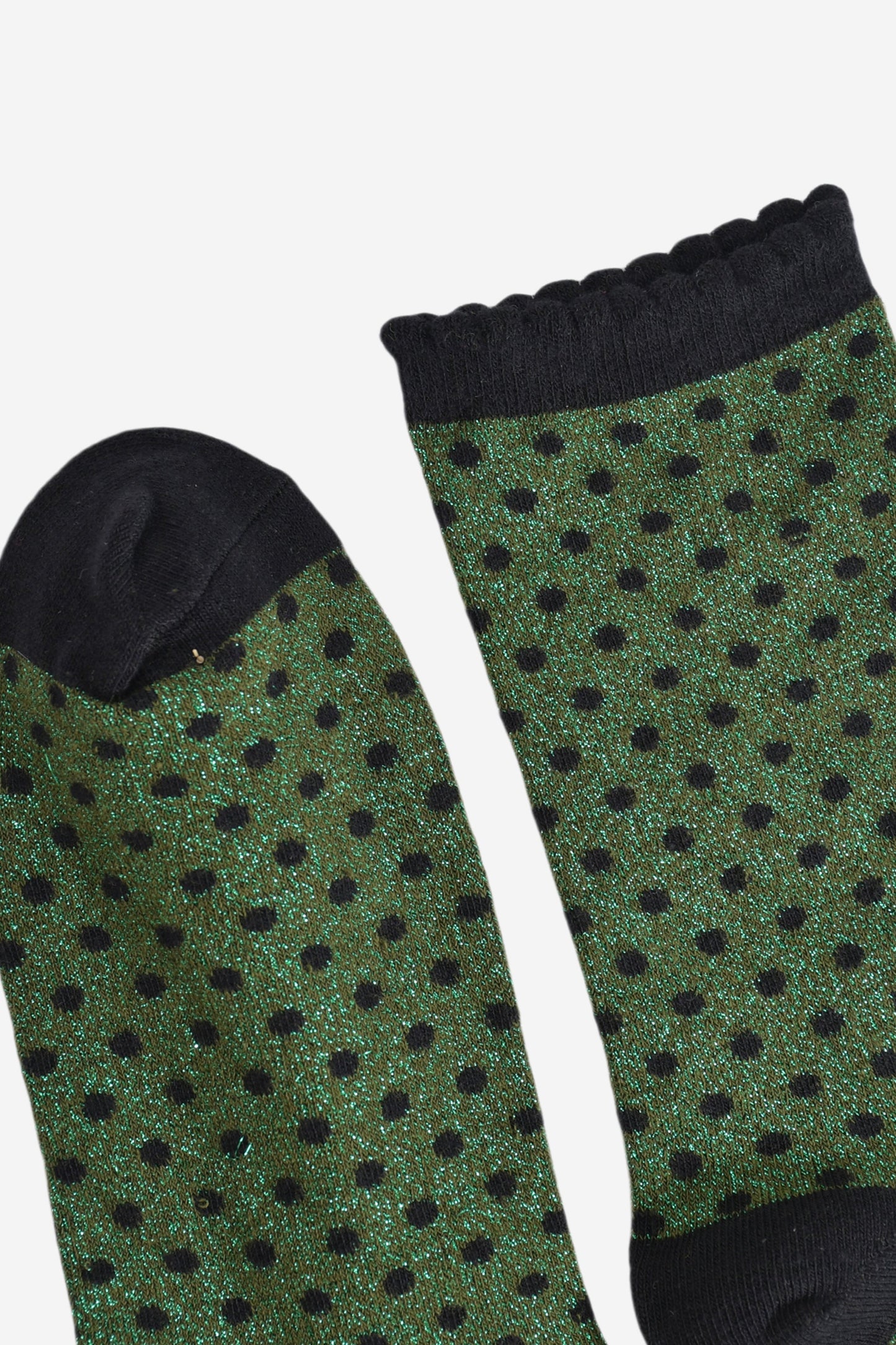 close up of the cuff and toe of the socks, they are both black and the cuff is scalloped