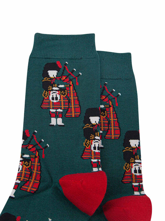 close up of the highland bagpiper wearing a traditional red kilt