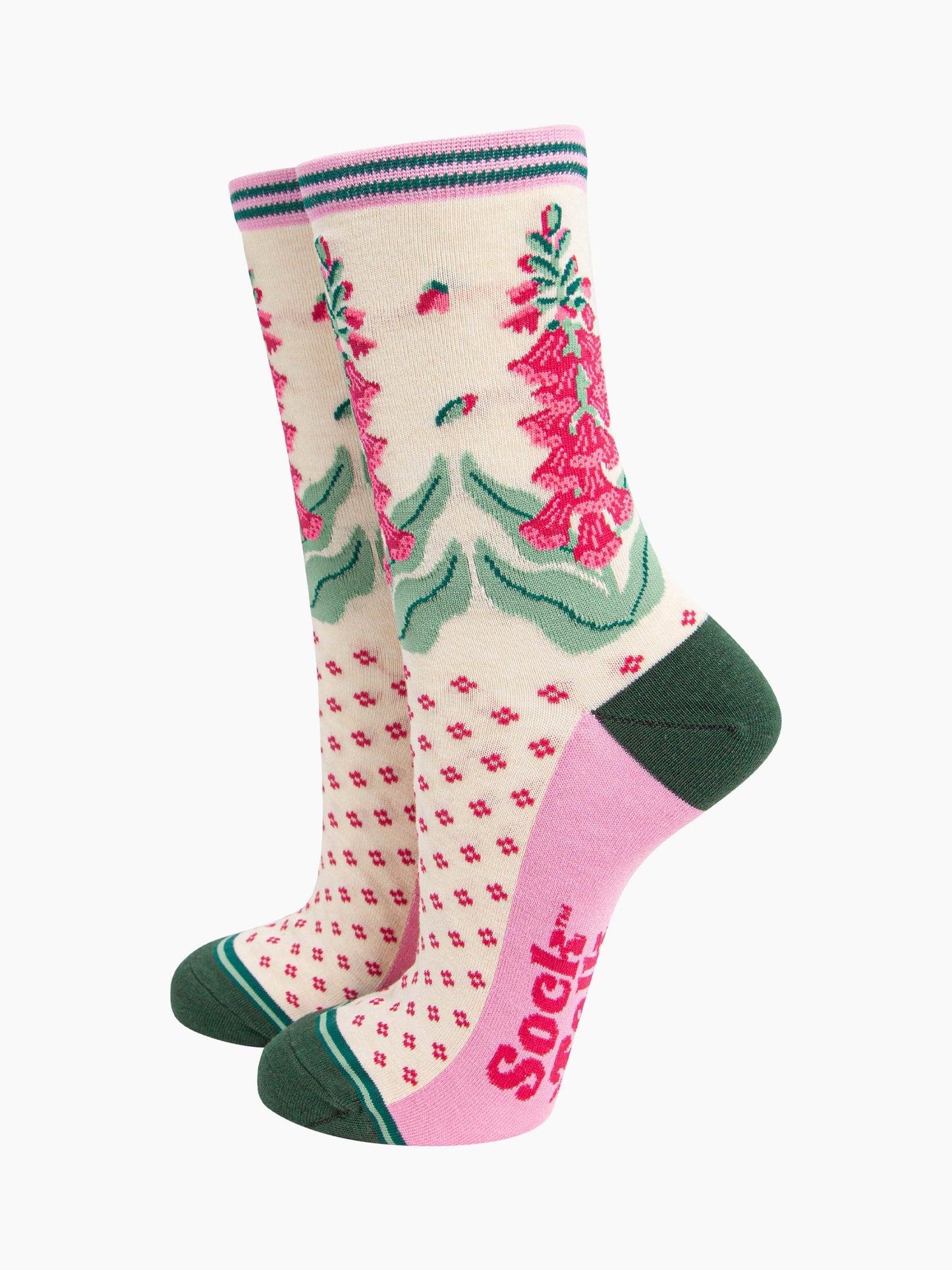 cream bamboo socks with a dark green heel and toe and light pink sole. the ankle of the socks is covered with fuchsia pink and green foxgloves.