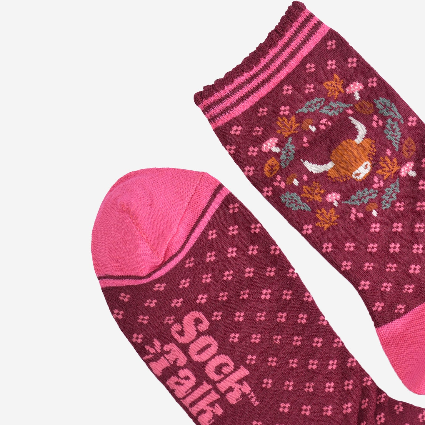 close up of the toe and cuff on the bamboo socks, the toe is pink with a burgundy stripe outline, the cuff is scalloped and has pink stripes