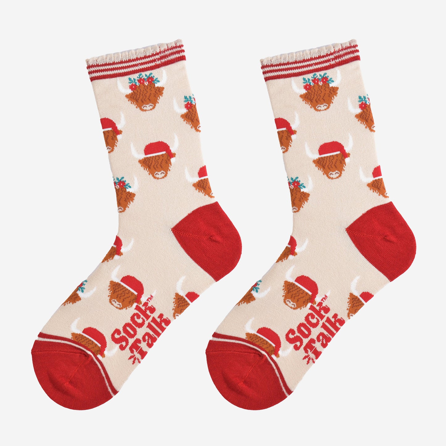 cream and red highland cow bamboo socks laying flat, showing the all over pattern of highland cows wearing santa hats and festive garlands