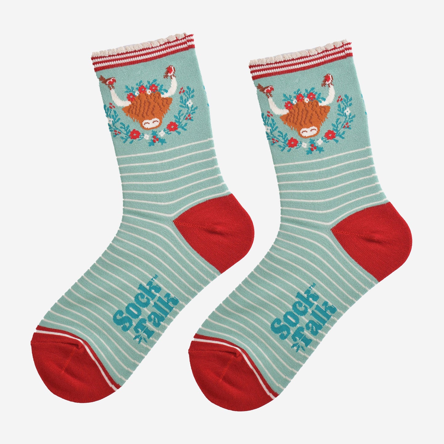 showing the socks laying flat, highlighting the white pinstripe pattern and large highland cow and wreath design on the ankle of the socks
