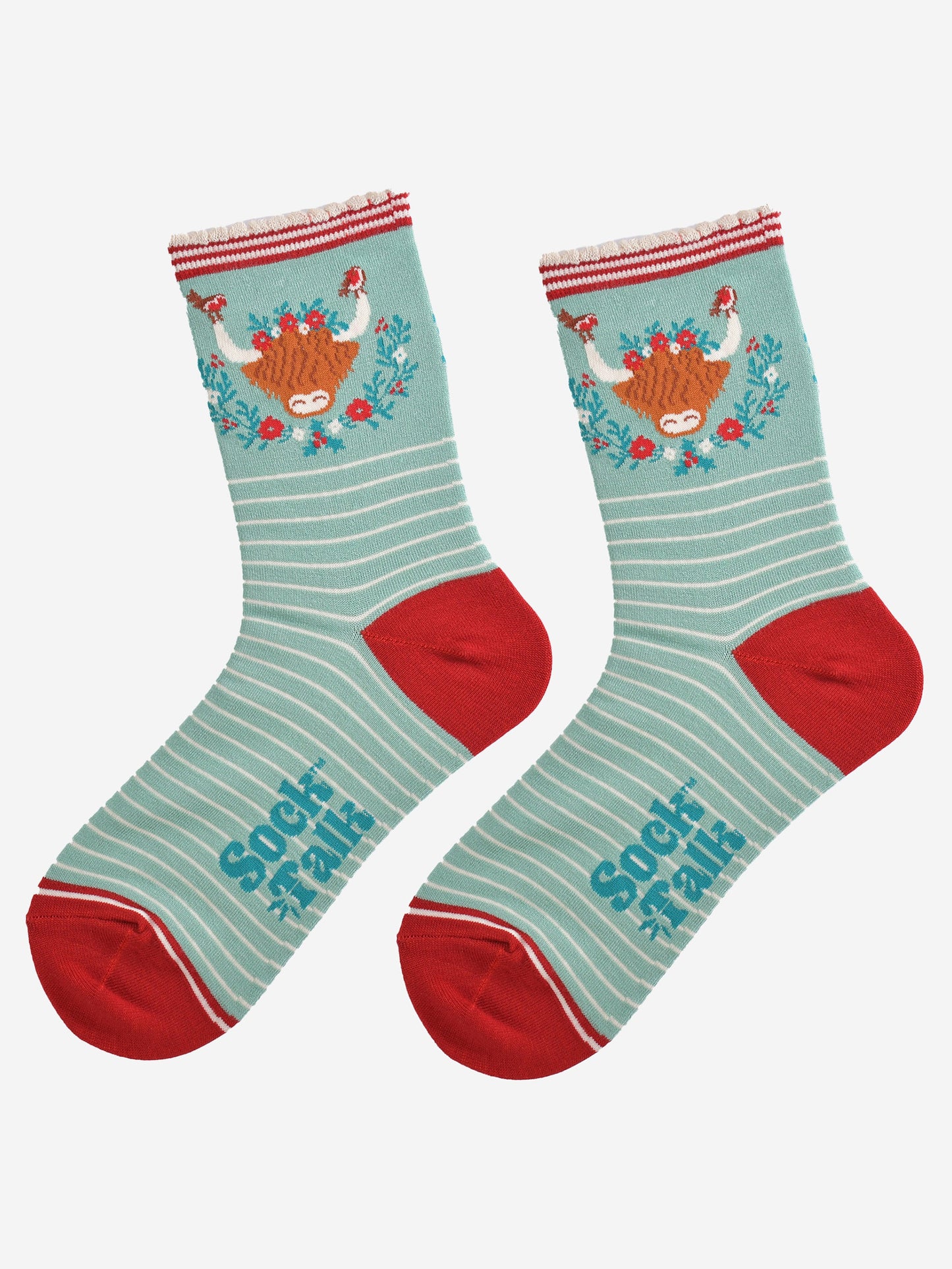 showing the socks laying flat, highlighting the white pinstripe pattern and large highland cow and wreath design on the ankle of the socks