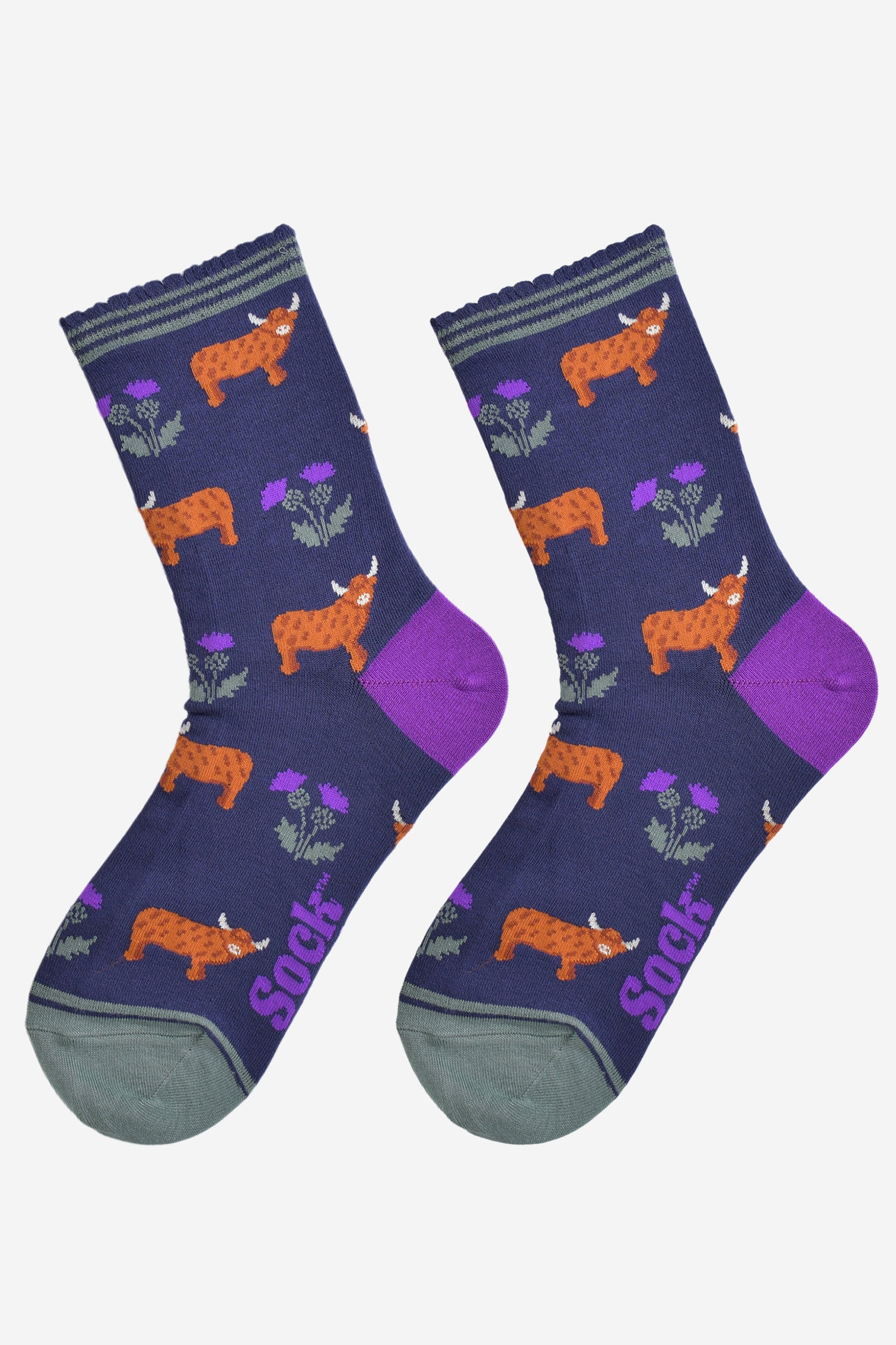 highland cow and thistle socks laying flat, showing the all over thistle floral pattern and standing highland cows