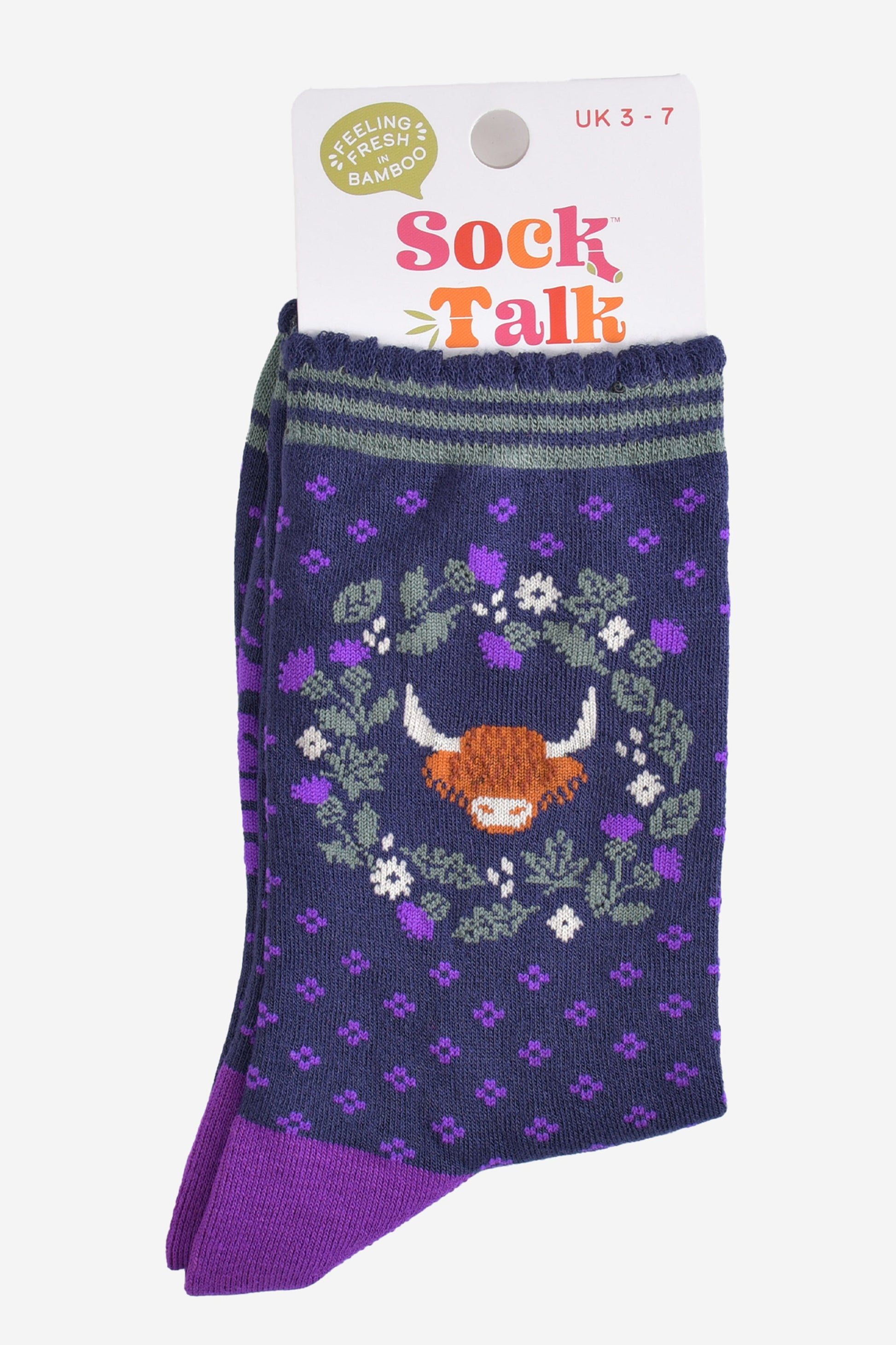 highland cow thistle wreath bamboo socks in their sock talk packaging, the socks are a uk size 3-7