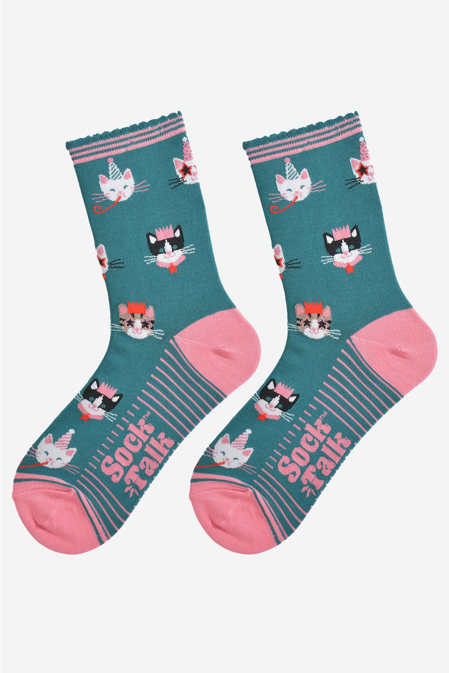 showing the green party cat socks laying flat, the sole has pink stripes and the cat face pattern is all over the socks.