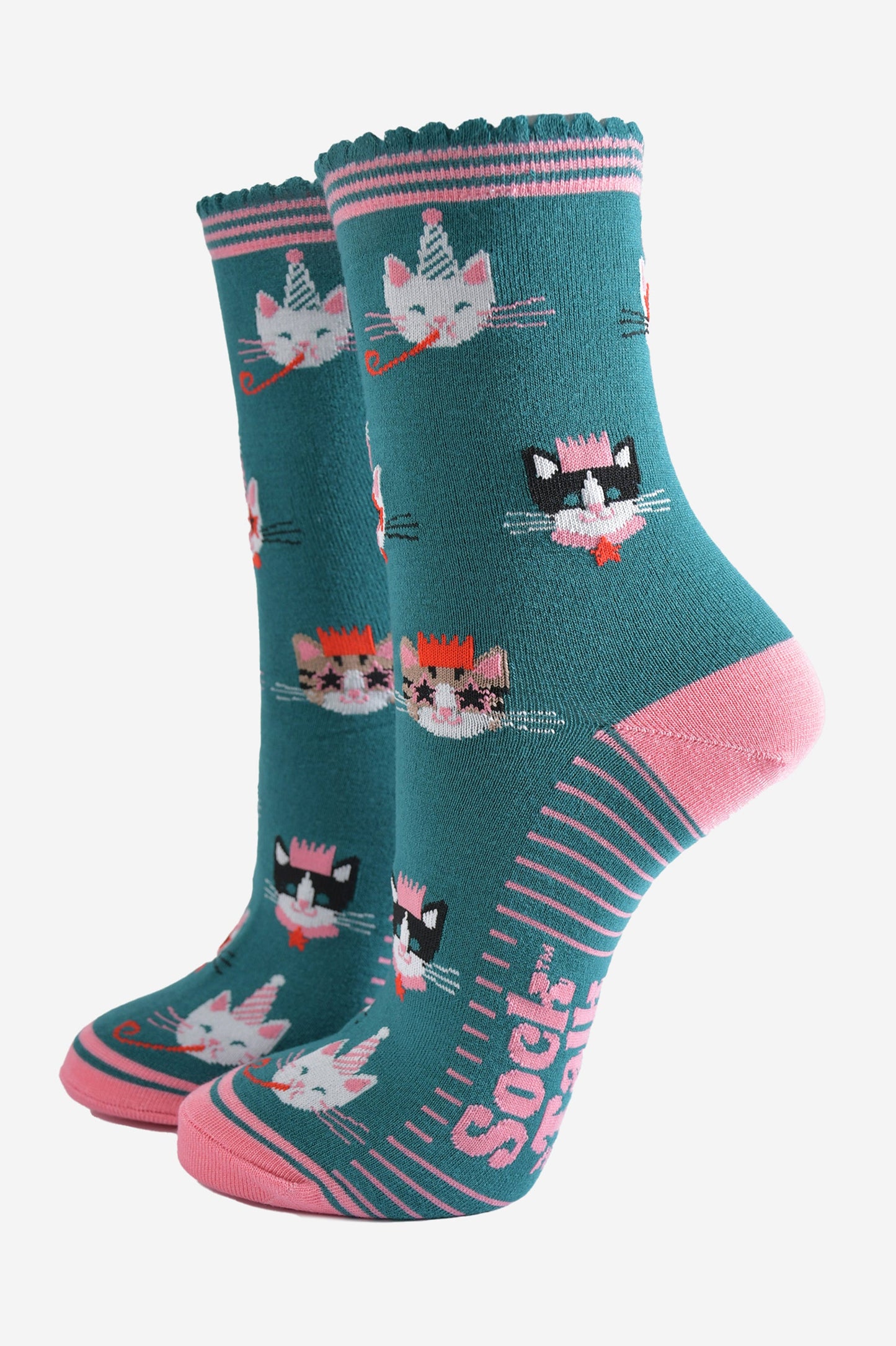 teal green socks with pink heel, toe and striped cuff with an all over pattern featuring cats wearing party hats