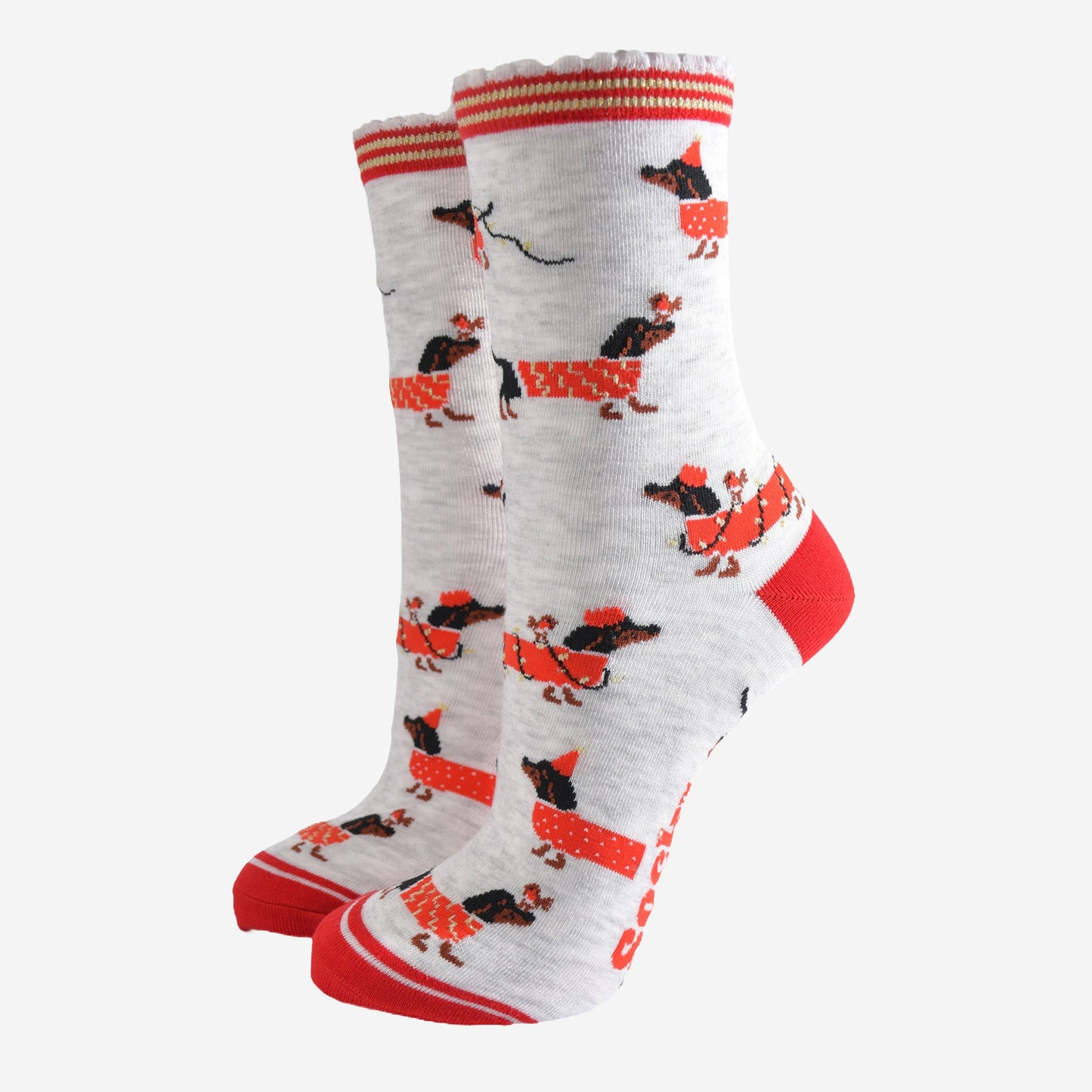 light grey socks with a red heel, toe and cuff with a pattern of dachshunds wearing xmas lights, jumpers and playing with red robin birds