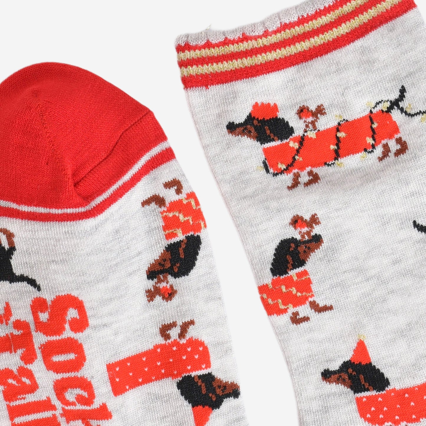 close up of the toe and cuff, the toe is red with a grey border stripe, the cuff is scalloped and has red and gold stripes