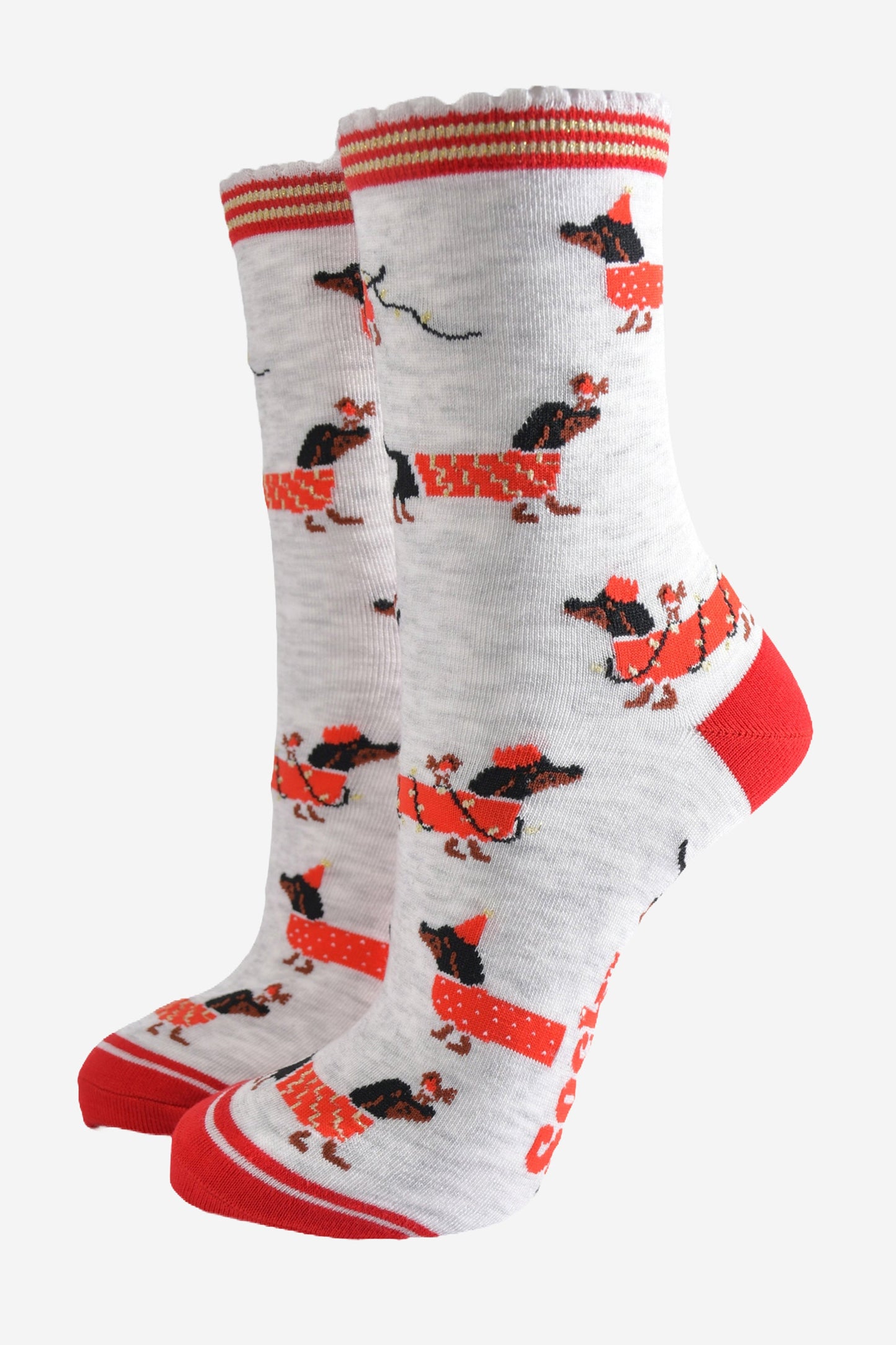 light grey socks with a red heel, toe and cuff with a pattern of dachshunds wearing xmas lights, jumpers and playing with red robin birds