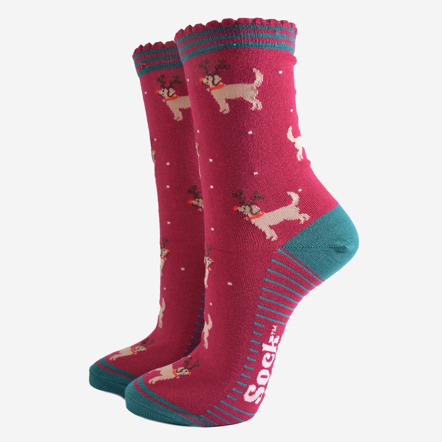berry red socks with a pattern of golden retriever dogs wearing xmas reindeer antlers
