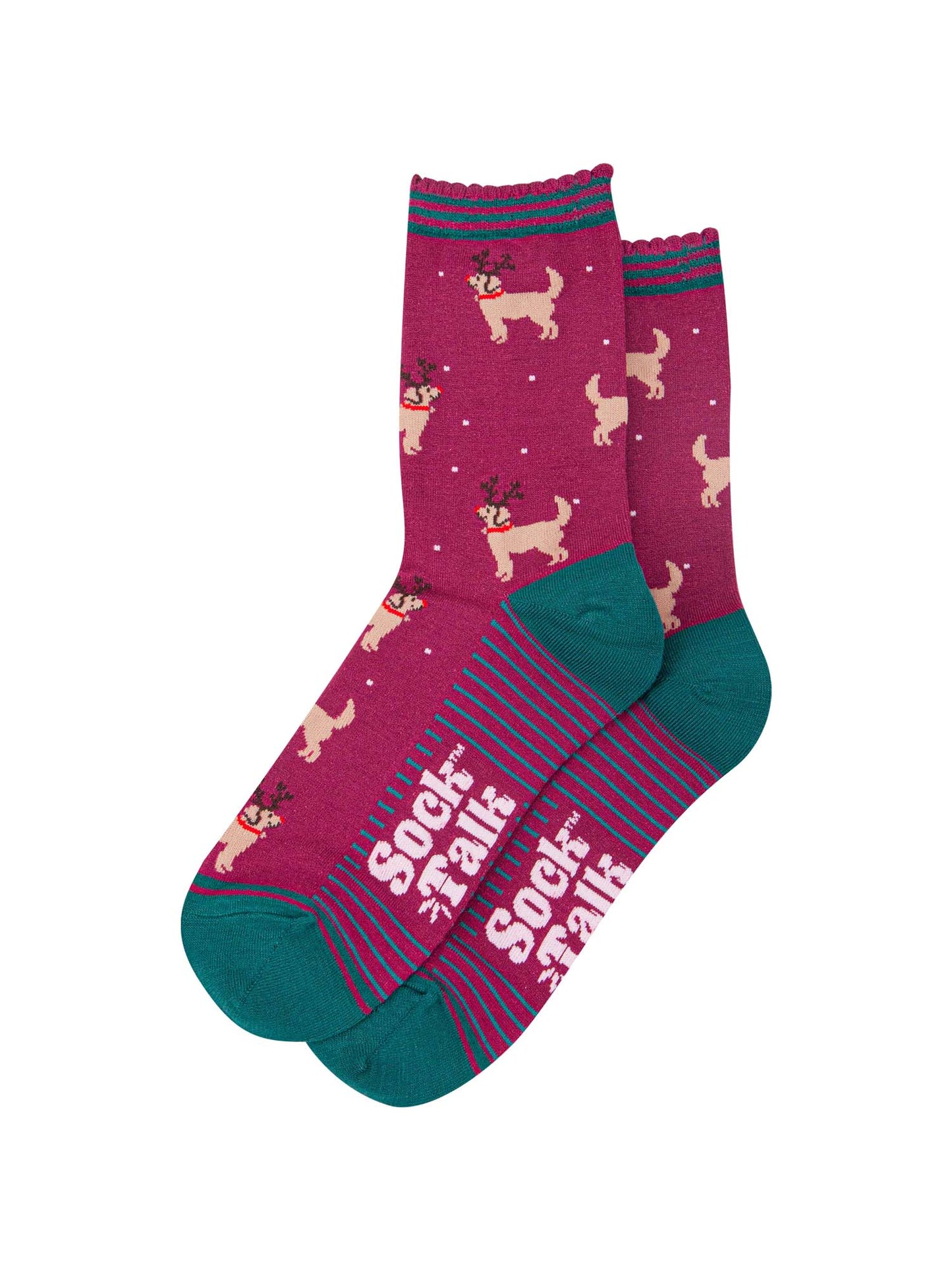 showing the golden retriever socks laying flat, the soles have green stripes, the dog pattern is all over the socks and there are also subtle falling snowflakes.