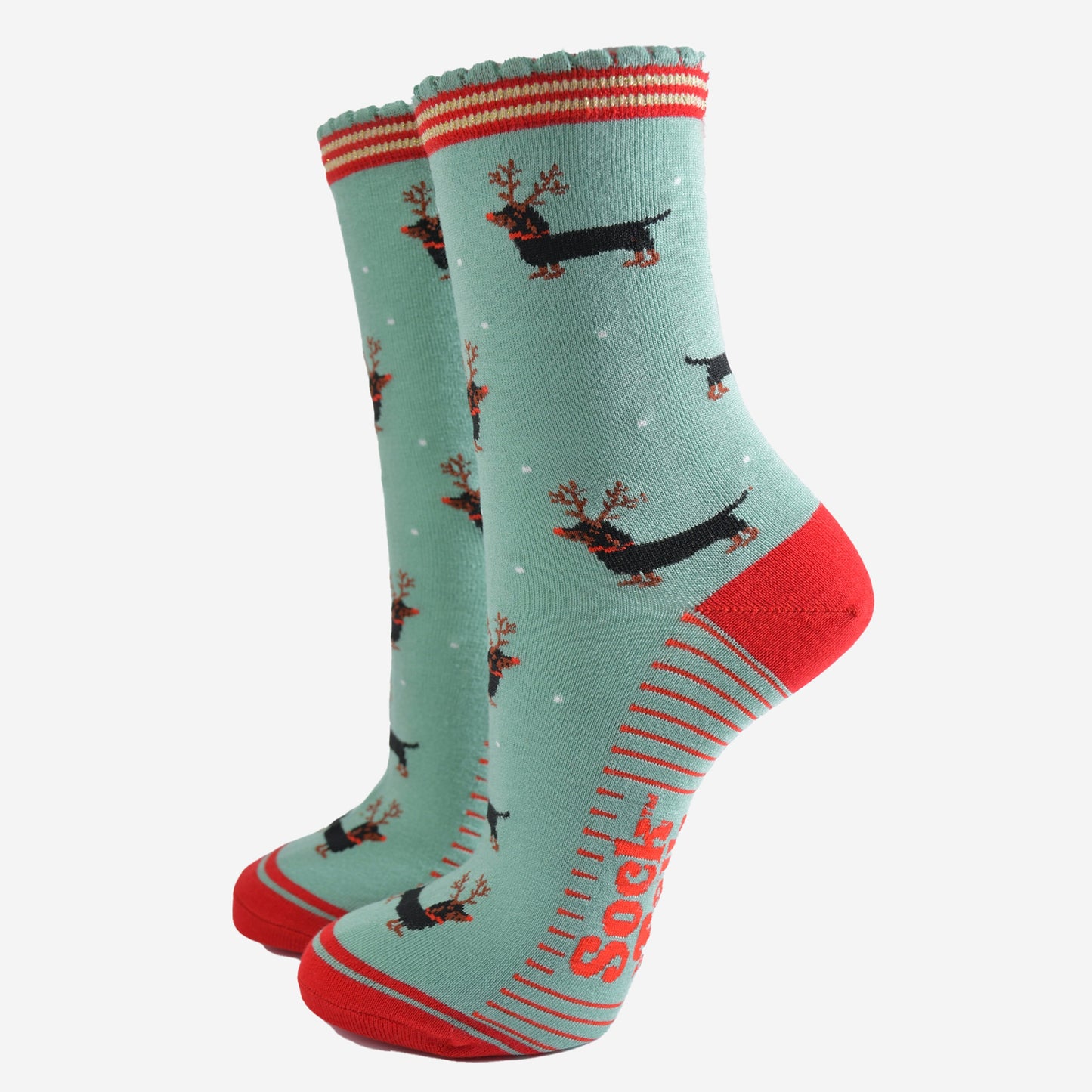 green and red ankle socks with a scalloped cuff and a pattern of dachshund dogs wearing reindeer antlers