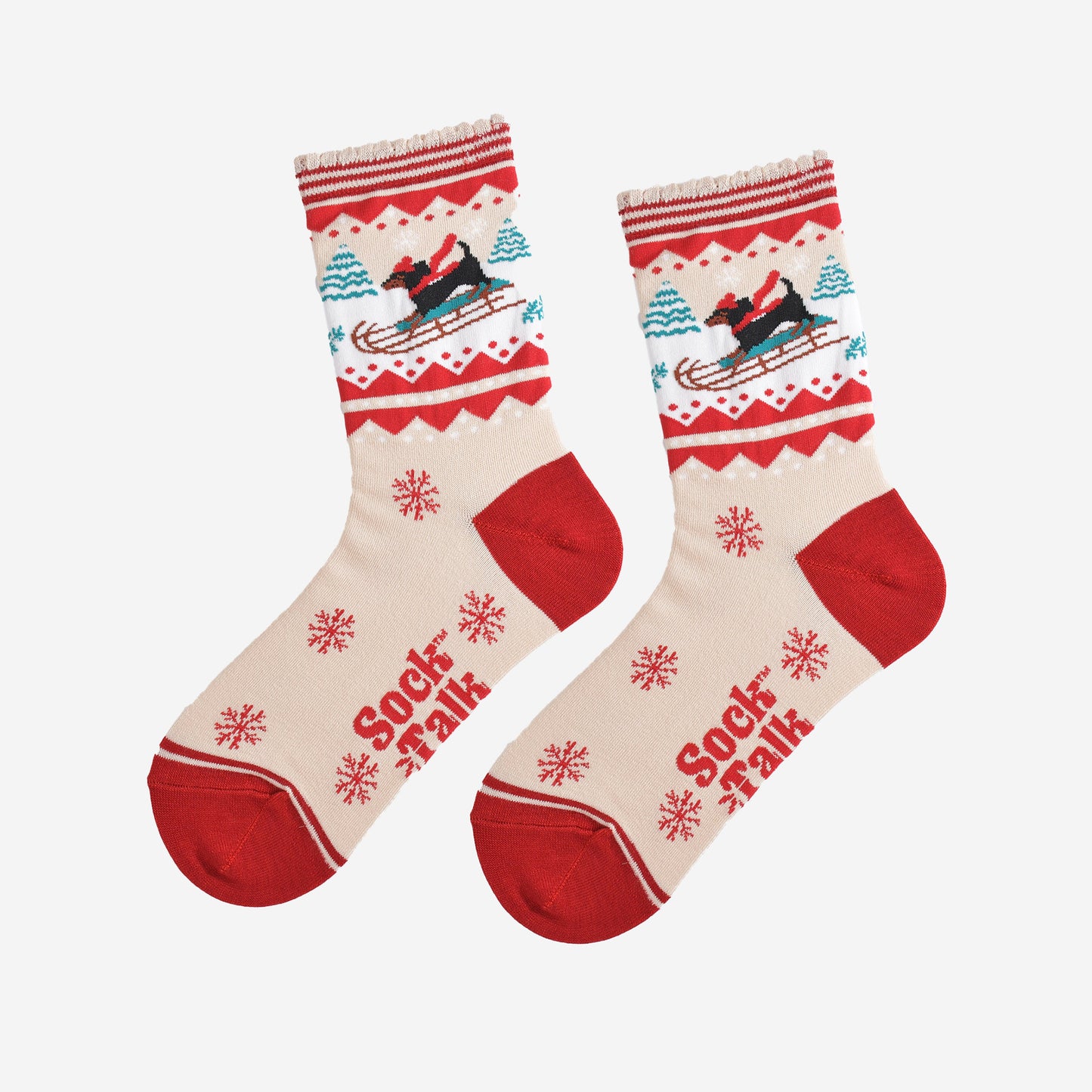 showing the sledging sausage dog socks laying flat, there is a pattern of large red snowflakes on the cream base of the socks