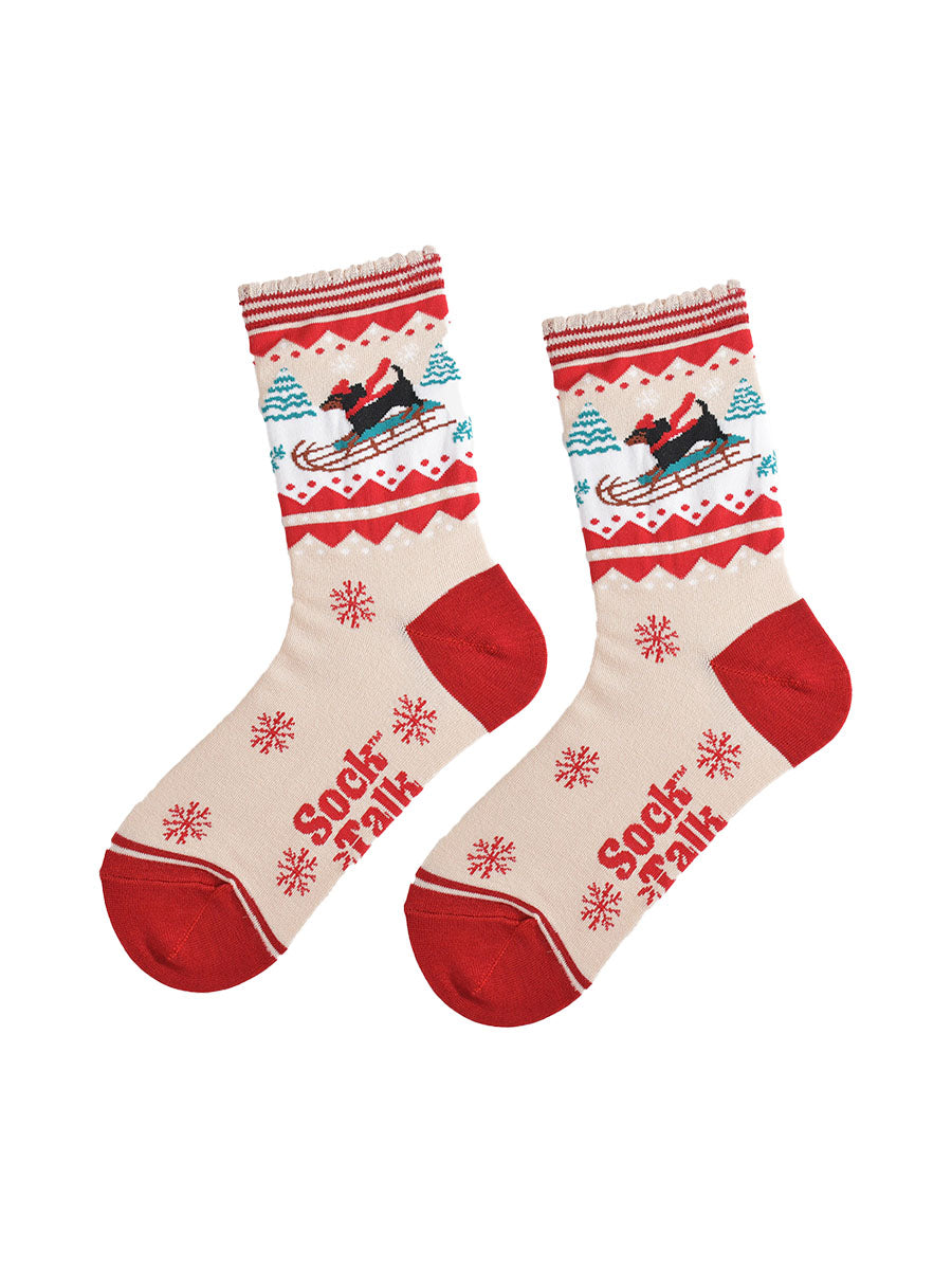 showing the sledging sausage dog socks laying flat, there is a pattern of large red snowflakes on the cream base of the socks