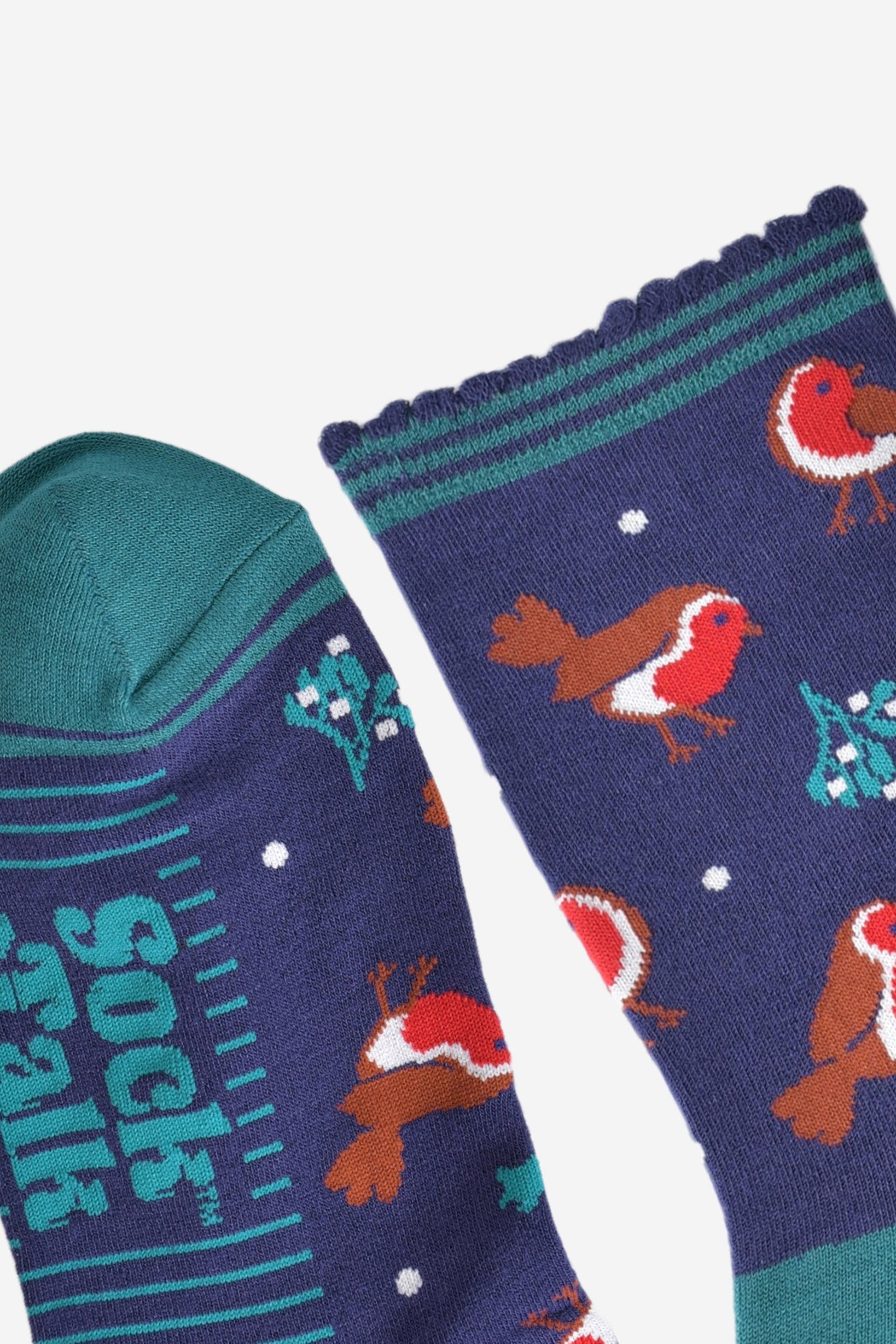 close up of the toe and cuff, the toe is green in contrast to the navy blue colour of the socks, the cuff is scalloped with three green horizontal stripes around the edges