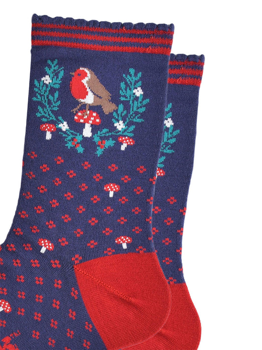 close up of the red robin and festive holly wreath on the ankle of the socks, the robin is perched on a red toadstool in the centre of the wreath, the wreath is horseshoe shaped and does not fully enclose the robin