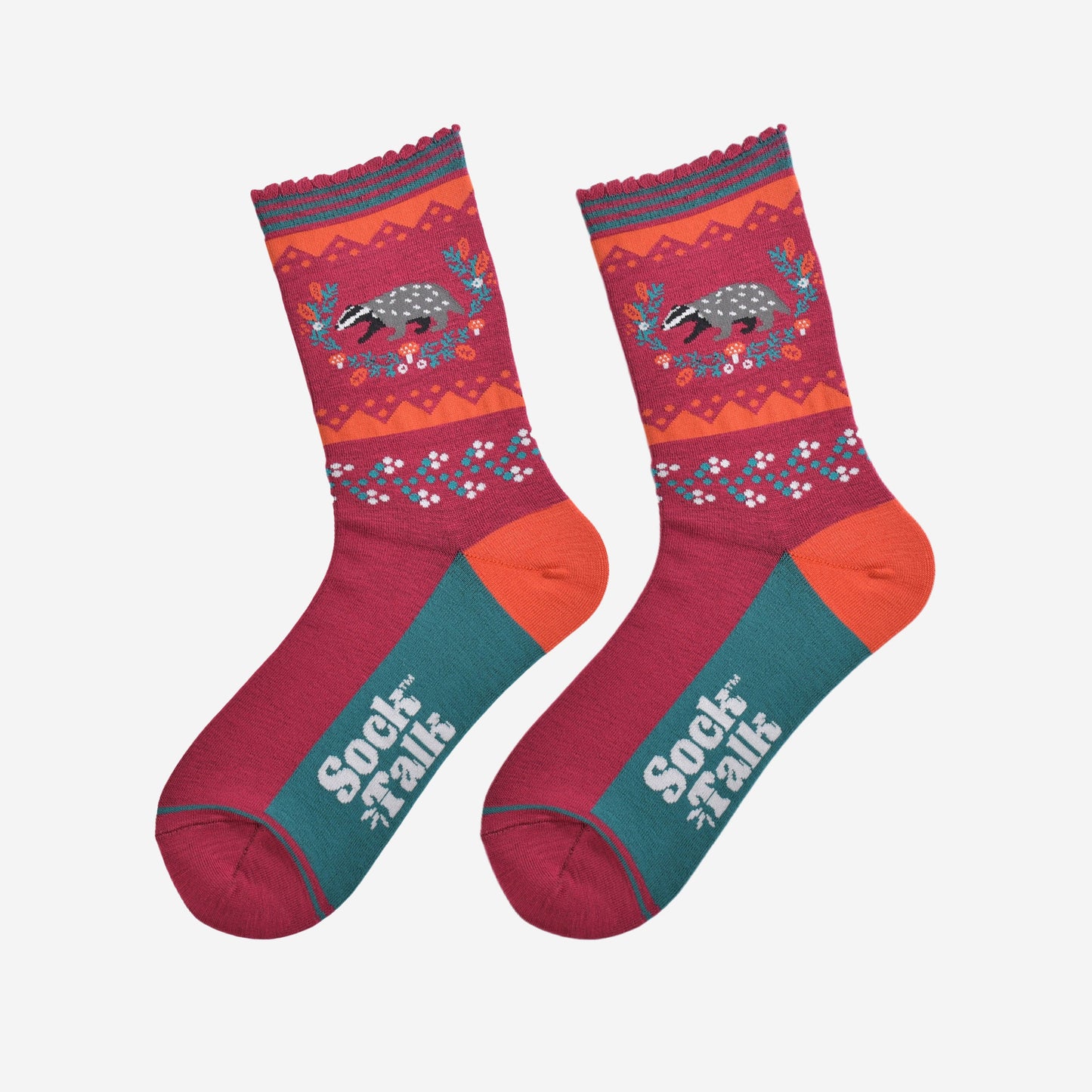 showing the badger wreath socks laying flat, the sole is green in contrast to the top of the socks, the badger on the ankle is surrounded by an autumnal foliage wreath