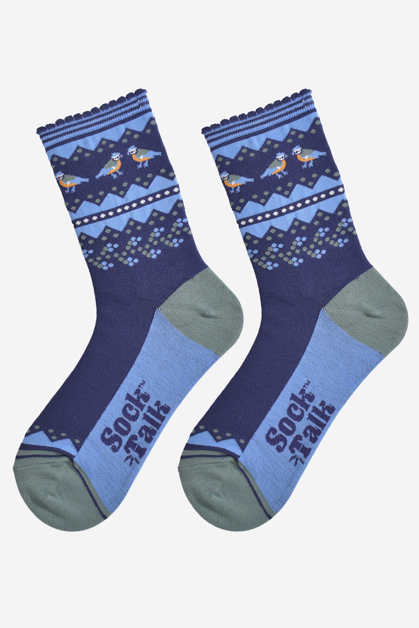 blue tit fair isle socks laying flat, showing the contrasting dark and light blue socks, with a decorative fair isle pattern around the ankles featuring blue tit garden birds