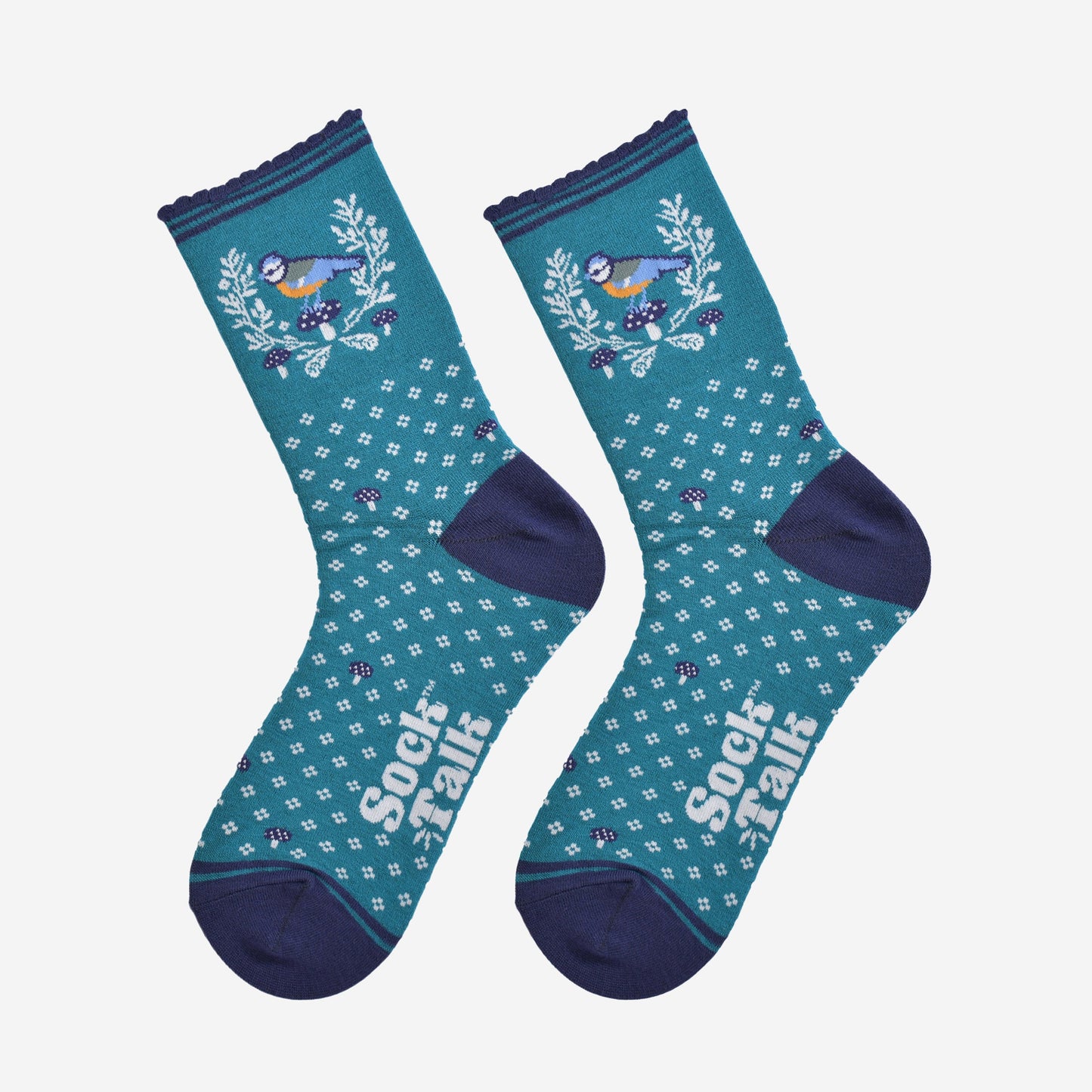 showing the blue tit wreath socks laying flat, detailing the all over floral pattern, wreath and blue tit bird