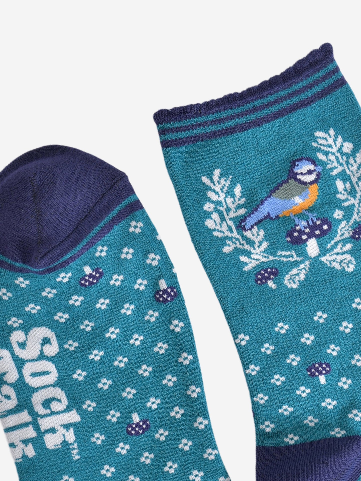 close up of the toe and cuff of the socks, the toe is navy blue in contrast to the light blue of the socks, the cuff is scalloped and is striped light blue and navy blue