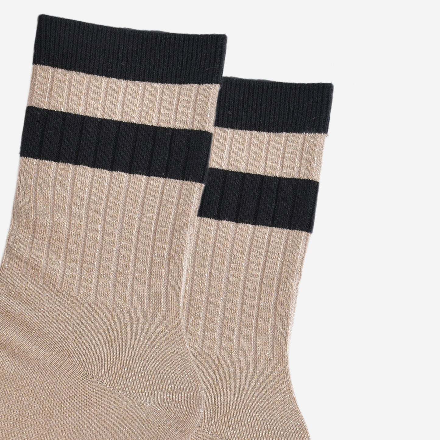 close up of the ribbed sports style cuffs on the socks. they have vertical ribbed details. the base of the socks are gold with a glitter sparkle. the cuff is black and there is a horizontal black band stripe, without glitter an inch below the cuff.