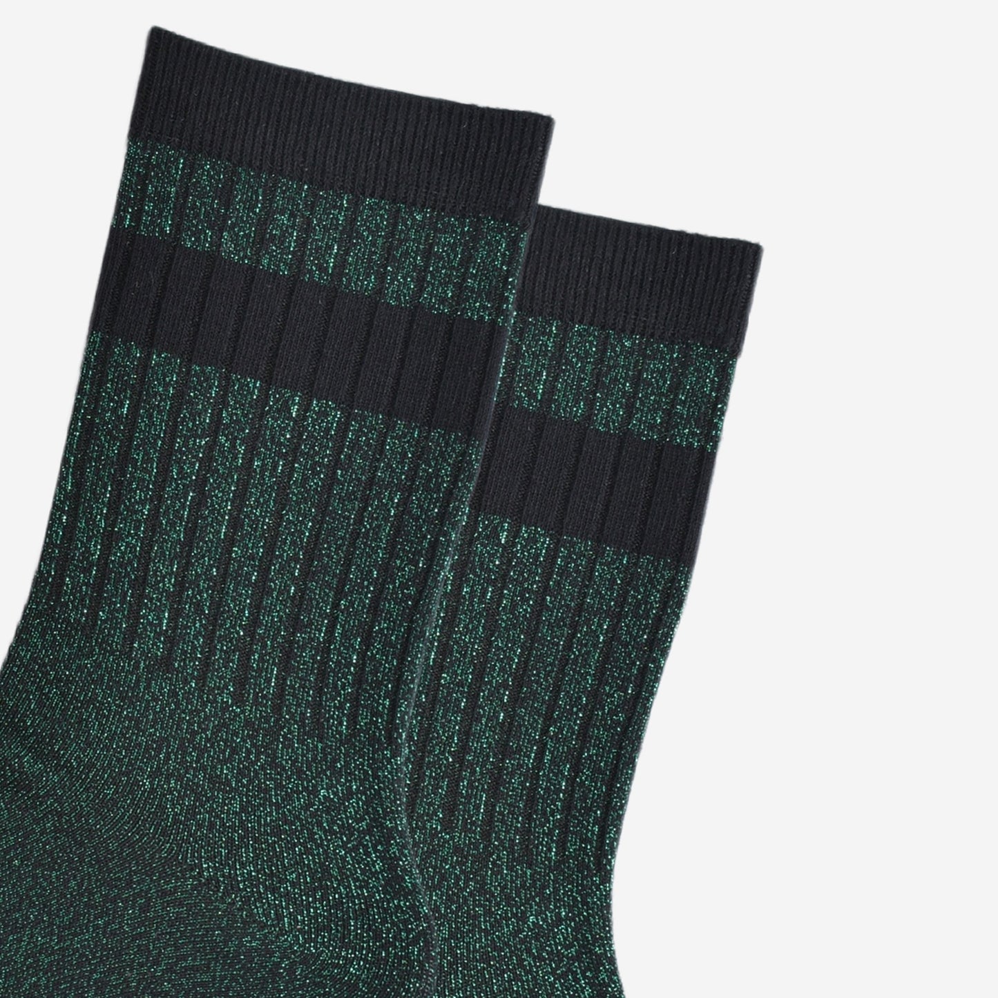 close up of the ribbed sports style cuffs on the socks. they have vertical ribbed details. the base of the socks are green with a silver glitter sparkle. the cuff is black and there is a horizontal black band stripe, without glitter an inch below the cuff.