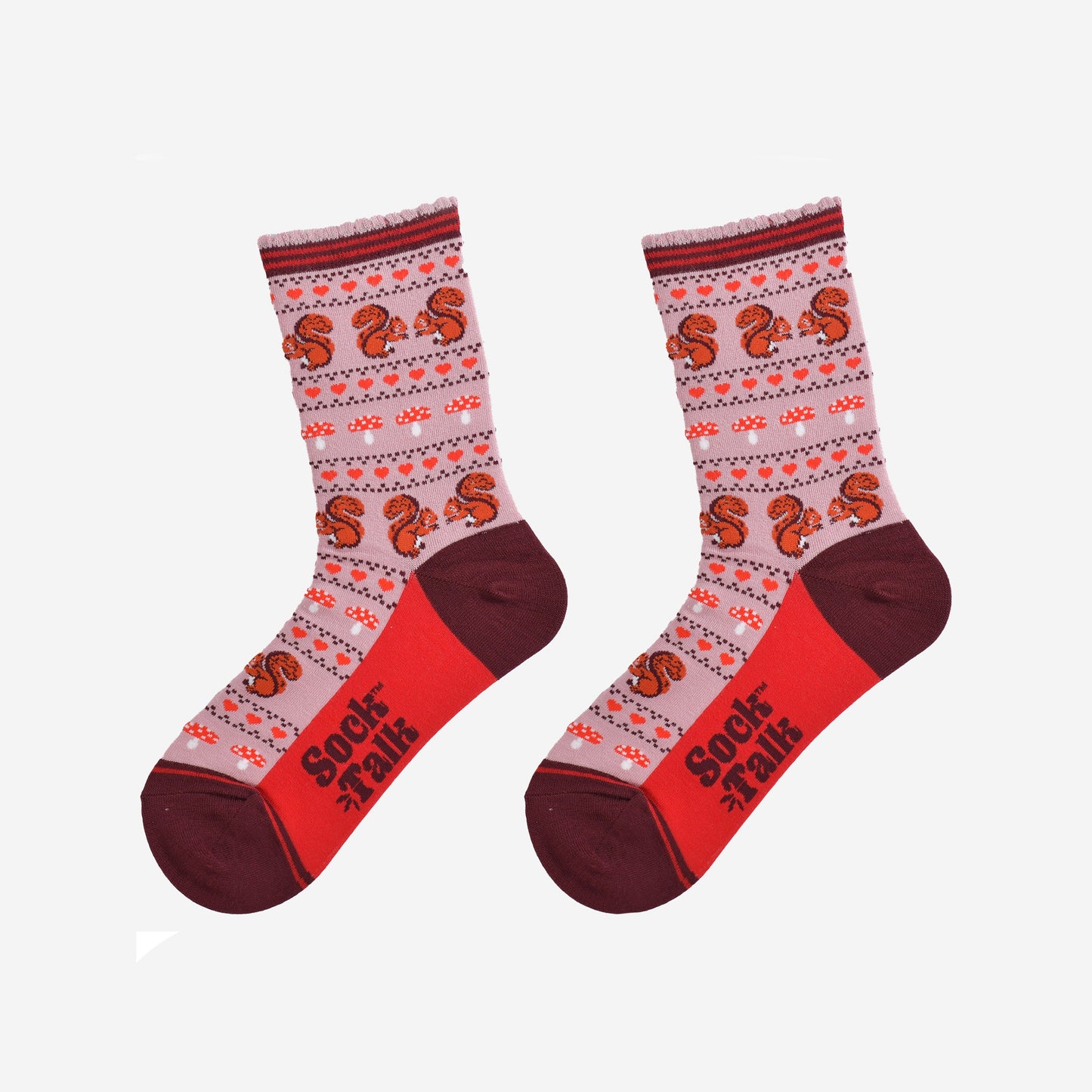 squirrel fair isle pattern socks laying flat, showing the all over pattern featuring red squirrels, toad stools and red love hearts