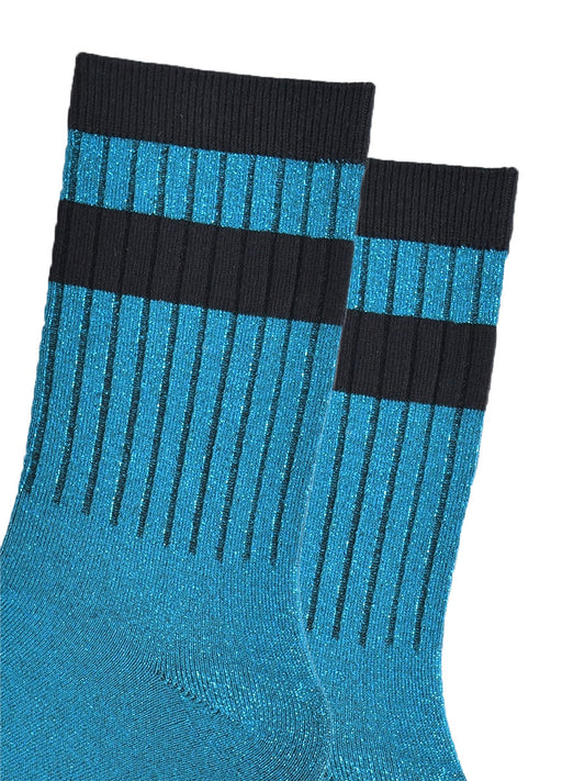 close up of the ribbed sports style cuffs on the socks. they have vertical ribbed details. the base of the socks are teal blue with a silver glitter sparkle. the cuff is black and there is a horizontal black band stripe, without glitter an inch below the cuff.