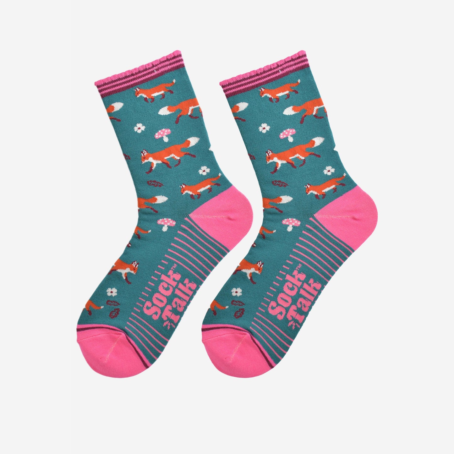 red fox woodland socks laying flat, showing the all over fox, leaf and toad stool pattern and pink accents