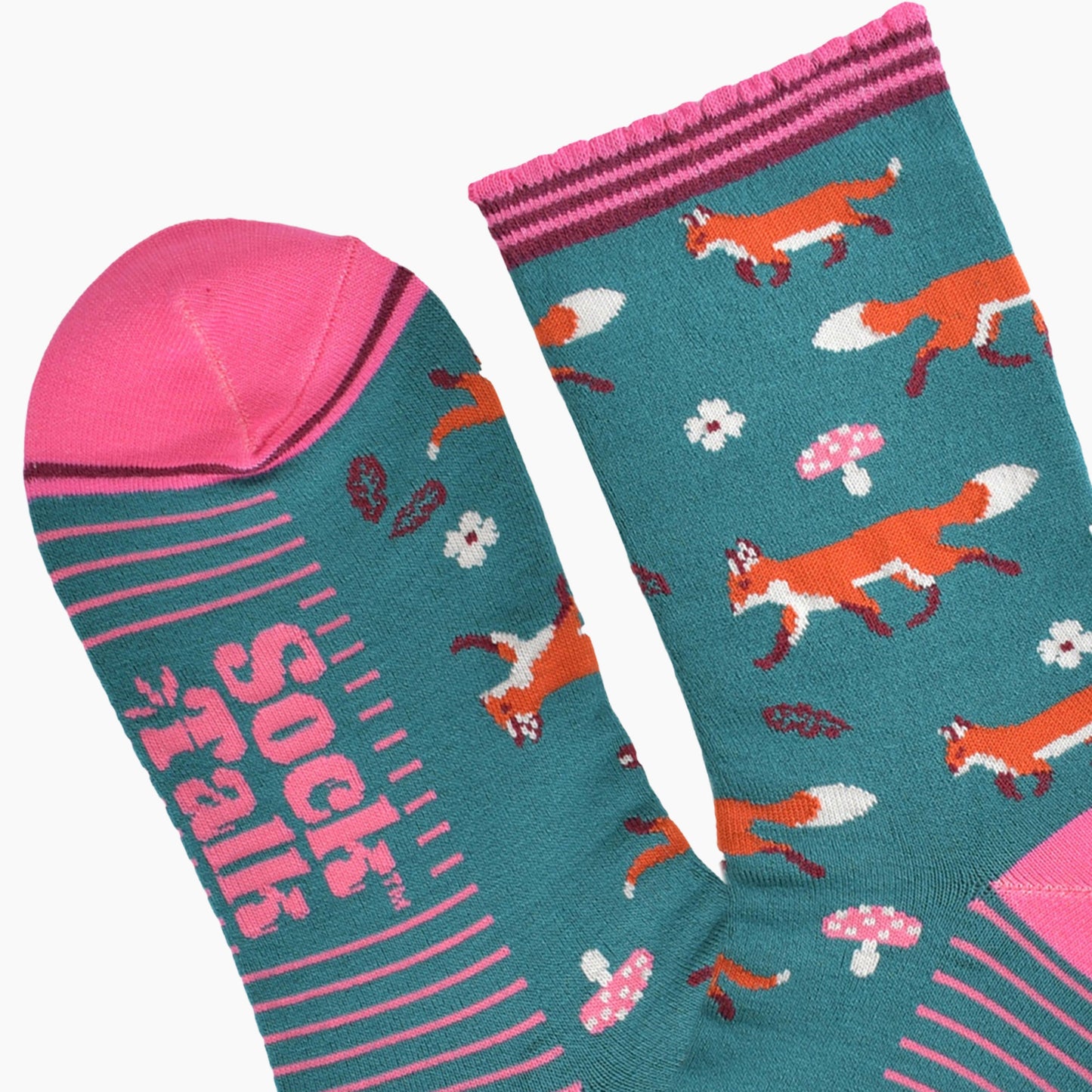close up of the toe and cuff, the toe is pink with a thin burgundy stripe, the cuff is scalloped and also pink and burgundy striped, the sole of the socks have pink stripes on them