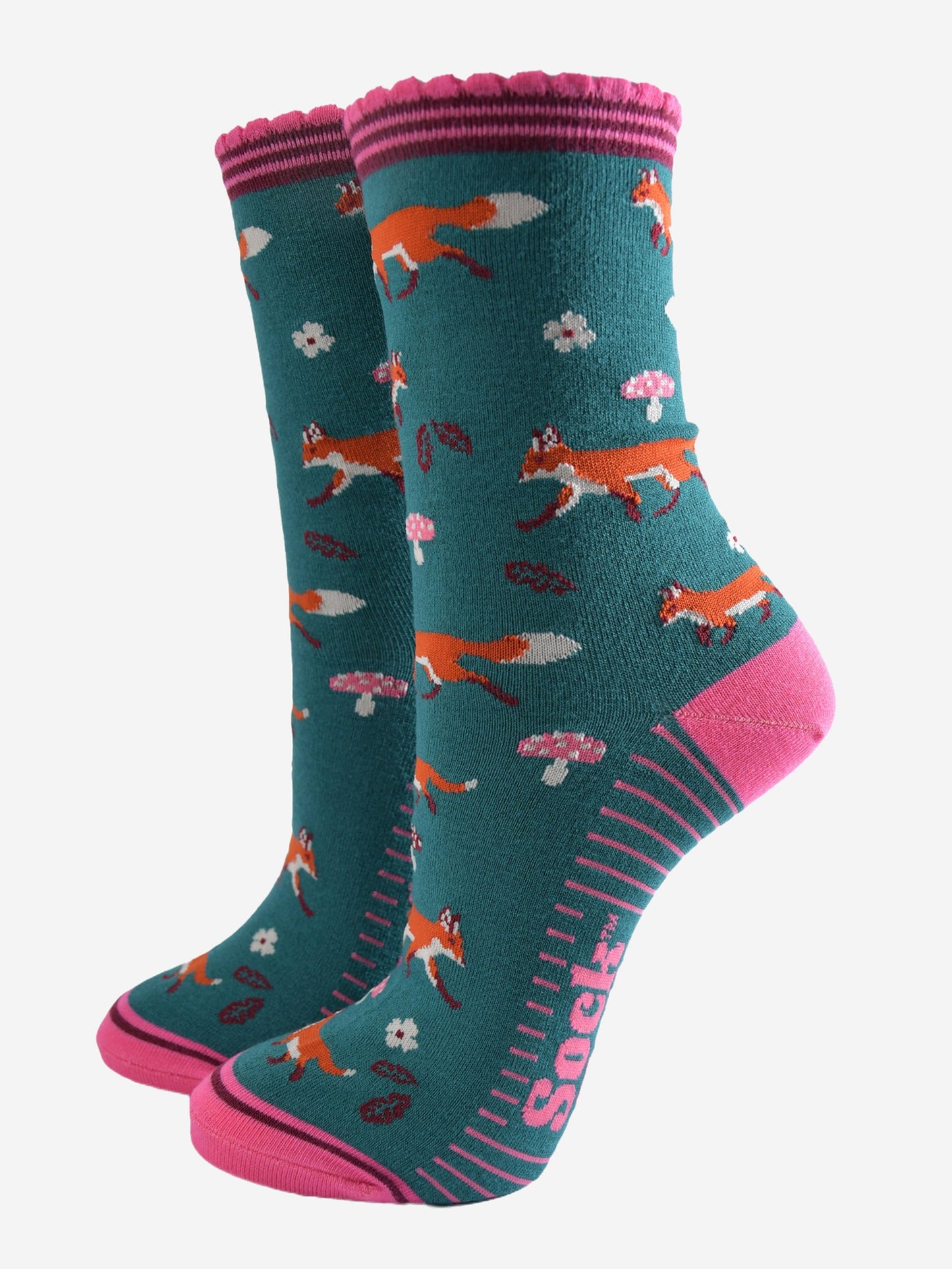 green socks with pink accents and an all over pattern featuring red foxes and toadstools