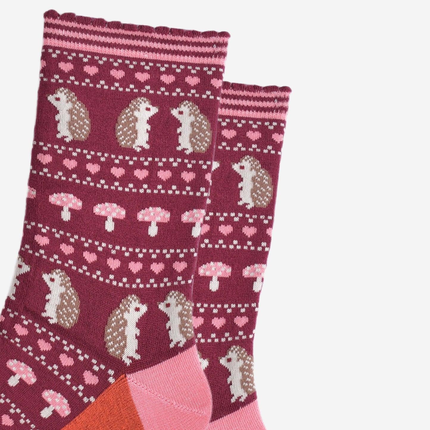 close up of the fair isle style design, showing hedgehogs, toadstools and love hearts in defined rows