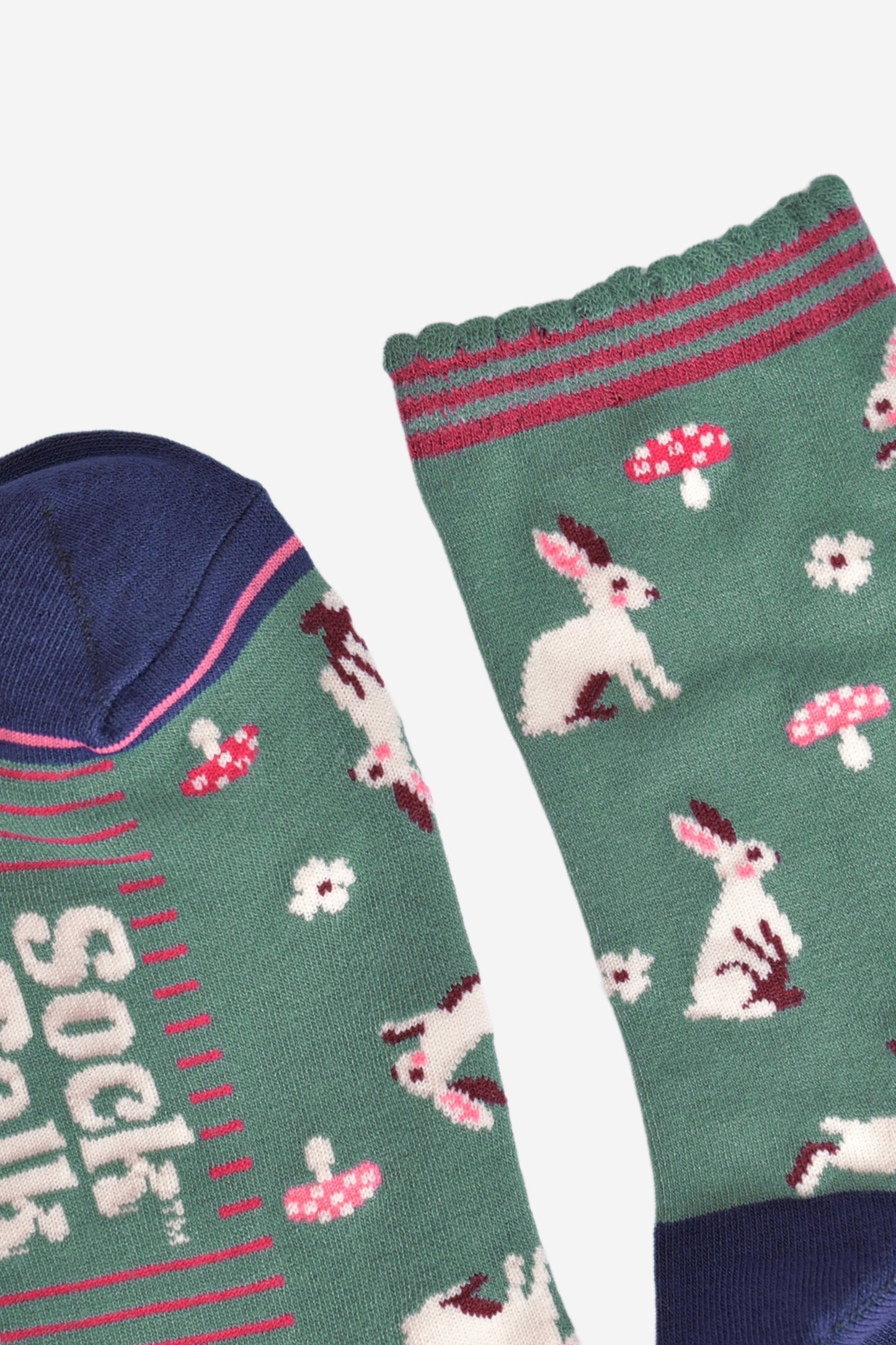 close up of the toe and cuff, the toe is navy blue with a pink border stripe, the cuff is green and scalloped with pink stripes