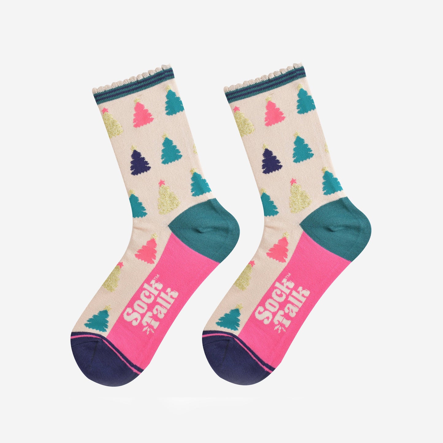 showing the christmas tree socks laying flat, the sole is hot pink in contrast to the cream body of the socks. the xmas tree pattern is all over an in a variety of colours, pink, gold, blue and green
