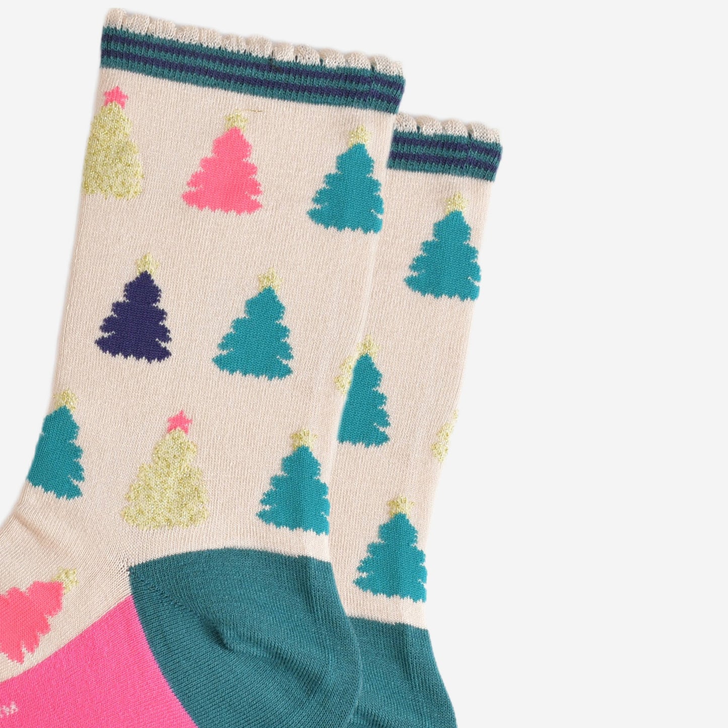 close up of the colourful christmas tree pattern, there are gold, pink, green and blue trees each with stars on the top